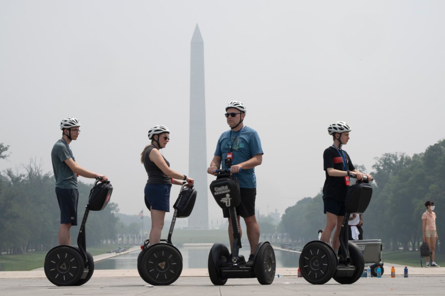 Tourists on Segways visit the Lincoln Memorial while the sky is hazy with smoke from wildfires in Canada, obscuring the view of the Capitol and other buildings along the National Mall almost completely past the Washington Monument, Thursday, June 29, 2023, in Washington. (AP Photo/Jacquelyn Martin)