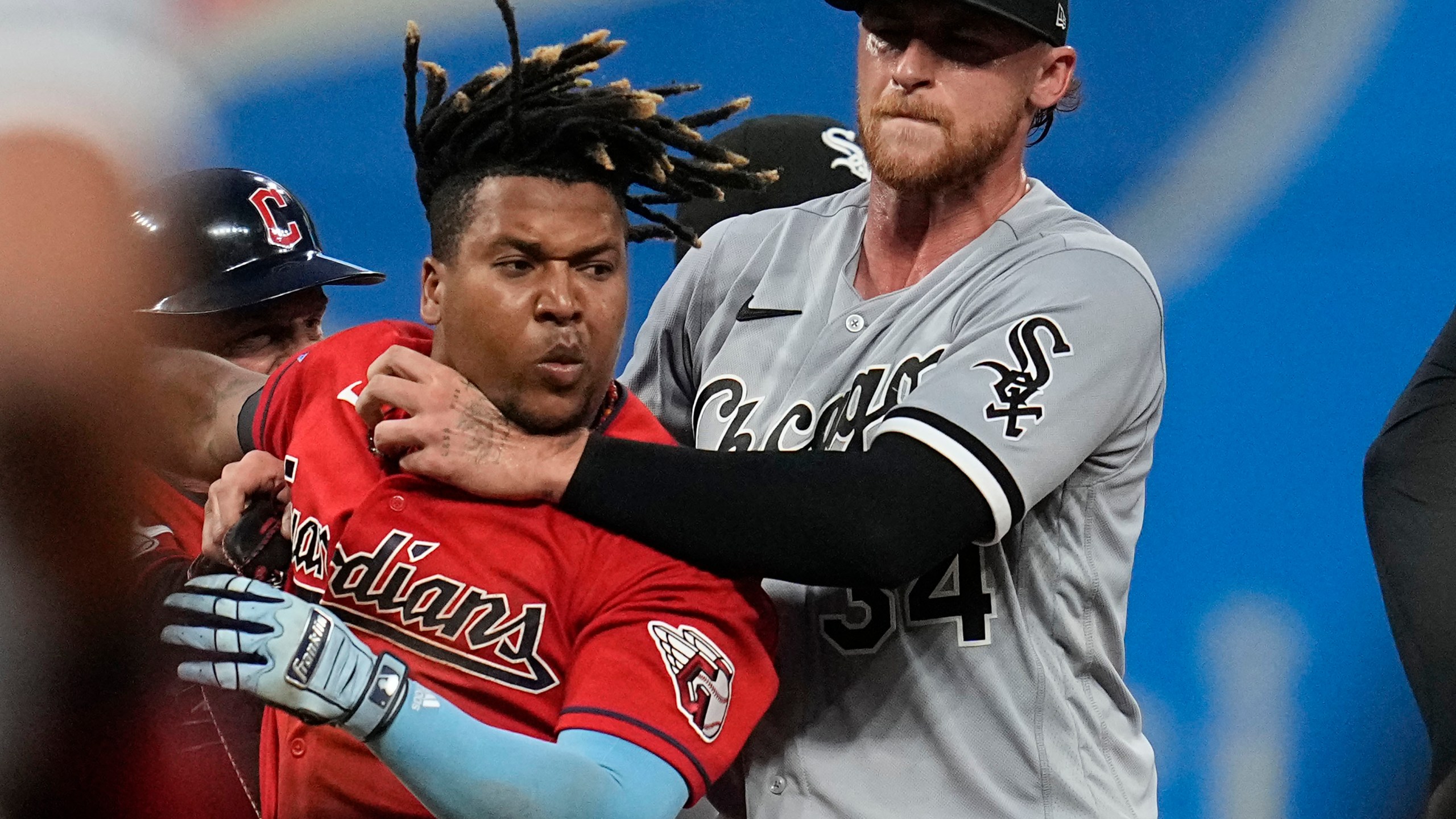 Chicago White Sox's Michael Kopech, right, holds back Cleveland Guardians' Jose Ramirez, second from right, as Ramirez and Tim Anderson fight in the sixth inning of a baseball game Saturday, Aug. 5, 2023, in Cleveland. (AP Photo/Sue Ogrocki)