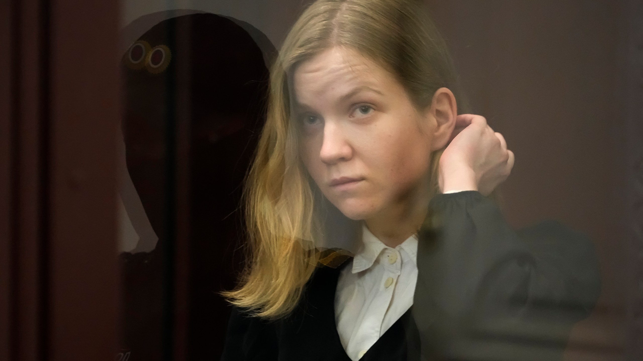 Darya Trepova, a suspect in a bombing that killed a well-known Russian military blogger, stands in a glass cage as she attends a court hearing in the 1st Western District Military Court, in St. Petersburg, Russia, Wednesday, Nov. 15, 2023. A military court in St Petersburg starts a trial against a 26-year-old woman Darya Trepova who is charged with terrorism after an attack at a St. Petersburg cafe that killed Russian military blogger Vladlen Tatarsky. (AP Photo/Dmitri Lovetsky)