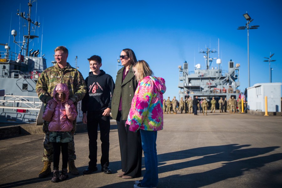 CW3 Jason West, left, skipper for LSV SP/4 James A. Loux, 7th Transportation Brigade (Expeditionary), stands with his family before deploying on Tuesday, March 12, 2024, at Joint Base Langley-Eustis in Hampton, Va. (AP Photo/John C. Clark)