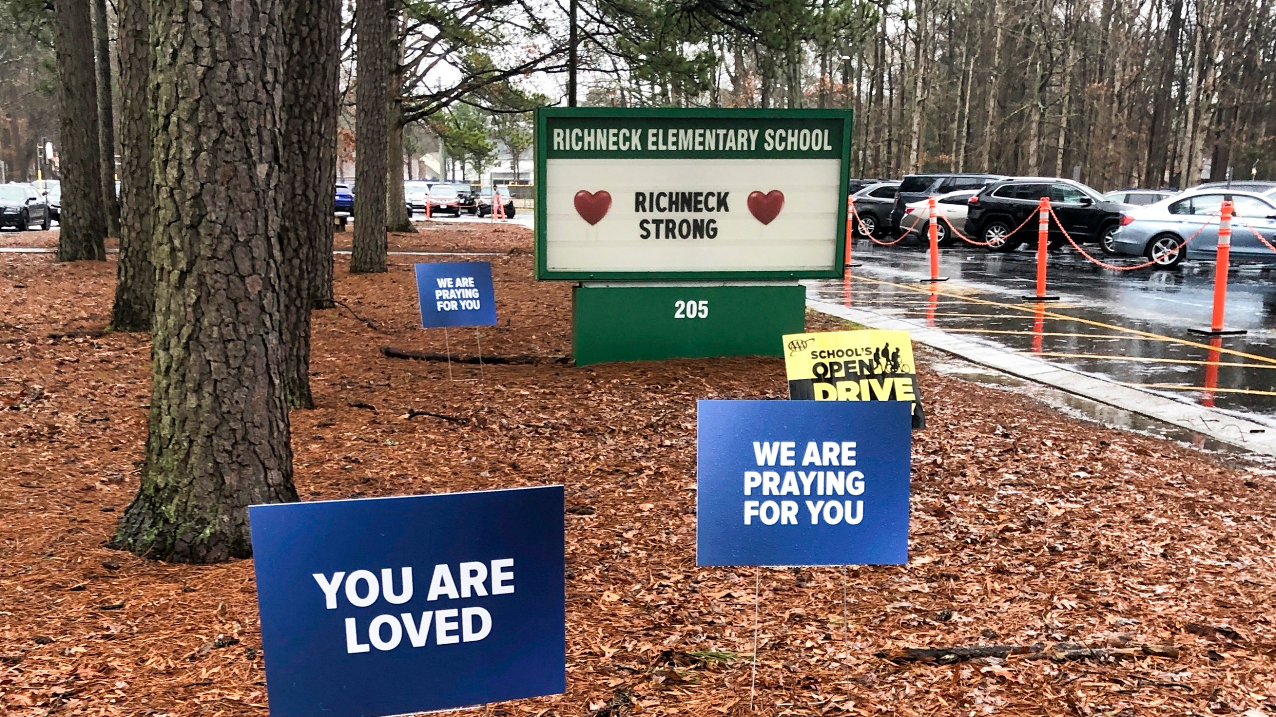FILE - Signs stand outside Richneck Elementary School in Newport News, Va., Jan. 25, 2023. A former assistant principal at a Virginia elementary school has been indicted on eight felony counts of child neglect in the case of a 6-year-old boy who shot and wounded his first-grade teacher in Newport News, Virginia, last year, according to indictments unsealed Tuesday, April 9, 2024, in Newport News Circuit Court. (AP Photo/Denise Lavoie, File)