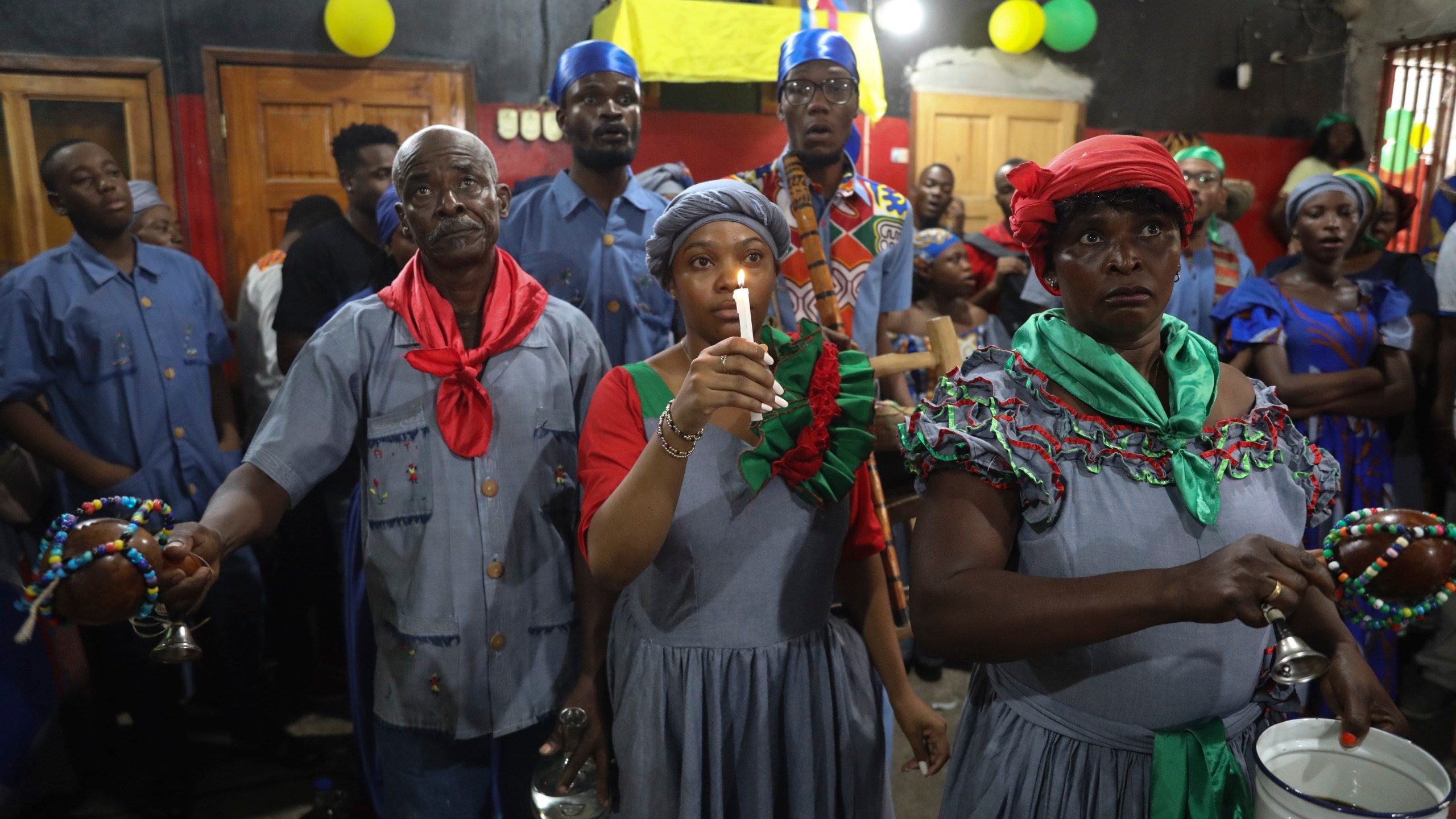 FILE - Vodou pilgrims attend a Mass marking the feast day of agriculture and work, in Port-au-Prince, Haiti, Wednesday, May 1, 2024. Amid the spiraling chaos, a growing number of Haitians are praying more or visiting Vodou priests known as “oungans” for urgent requests ranging from locating loved ones who were kidnapped to finding critical medication needed to keep someone alive. (AP Photo/Odelyn Joseph, File)