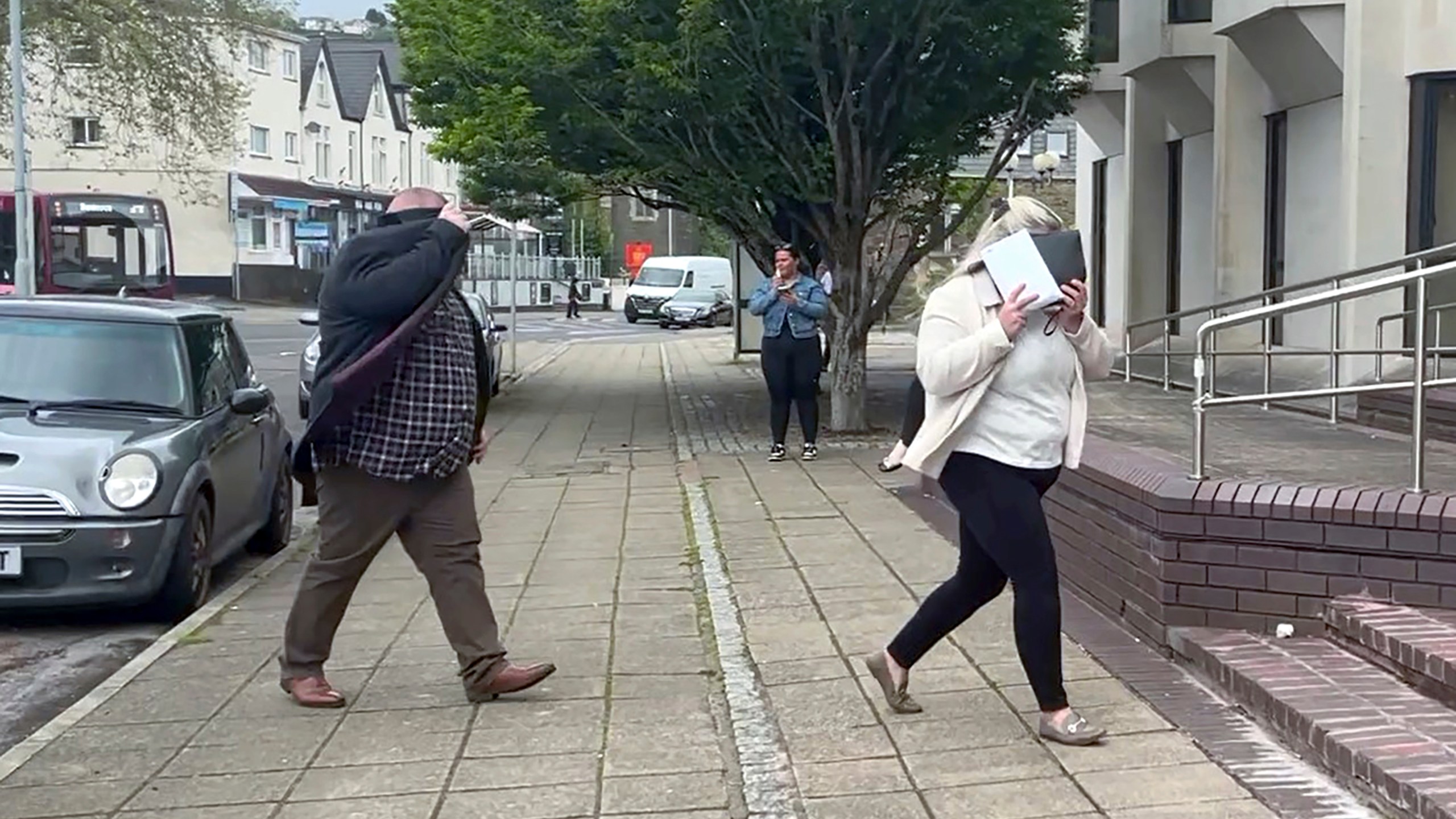 In this still image taken from video, Ann and Bernard McDonagh arrive at Swansea Crown Court in Wales, Wednesday, May 29, 2024. The couple were sentenced to prison for fraud for routinely ordering pricey meals at restaurants and then bolting when it came time to pay. (Claire Hayhurst/PA via AP)