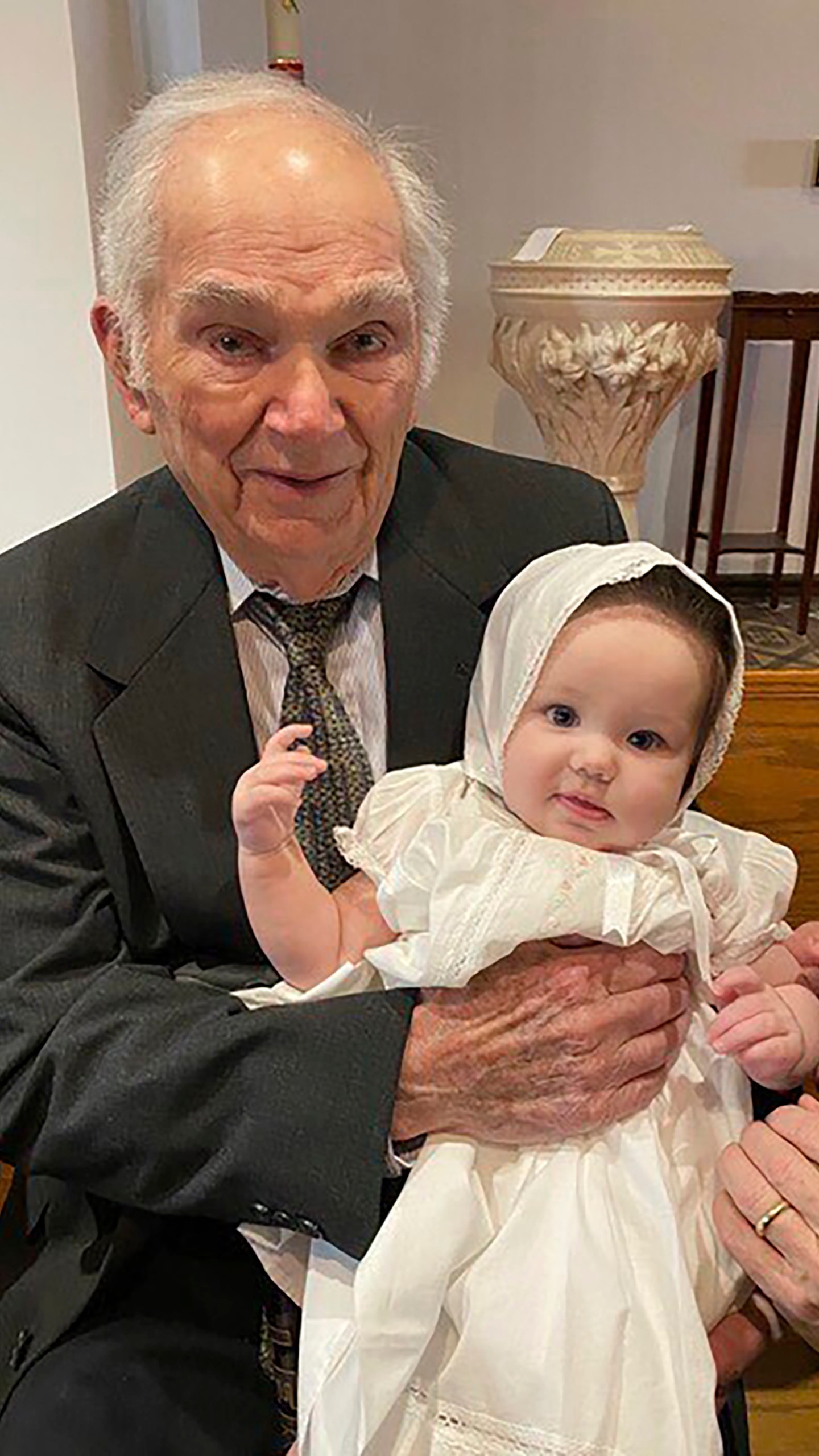 This undated photo provided by Linda Mitchelle shows Orville Allen of Poplar Bluff, Mo., holding his great-granddaughter at her baptism. Allen died Wednesday, May 29, 2024, and his liver was successfully donated and transplanted to a 72-year-old woman. Transplant organizations say Allen is the oldest American ever to donate an organ upon death. (Linda Mitchelle via AP)