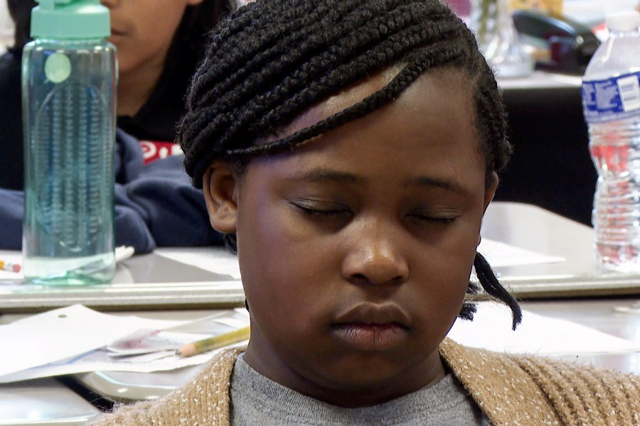 Aniyah Woods meditates during a mindfulness session in her classroom at Roberta T. Smith Elementary School, May 14, 2024, in Rex, Georgia. School districts across the U.S. have been introducing yoga, meditation and mindfulness exercises to help students manage stress and emotions. (AP Photo/Sharon Johnson)