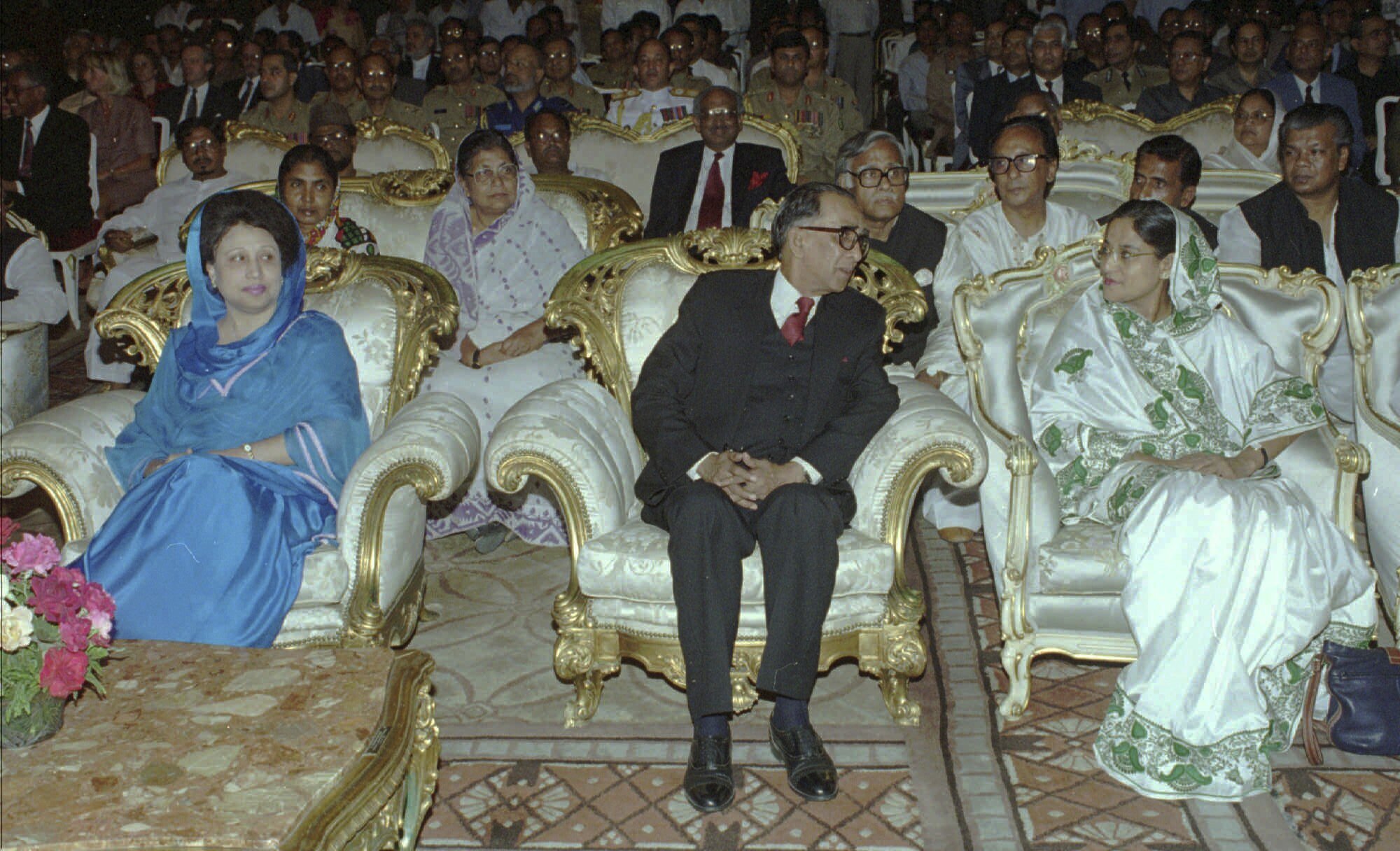 FILE- Former Bangladeshi Prime Minister Khaleda Zia, left, looks over as new interim leader Mohammad Habibur Rahman speaks with opposition Awami League leader Sheikh Hasina, right, at Rahman's swearing-in ceremony in Dhaka Saturday, March 30, 1996. (AP Photo/Pavel Rahman, File)