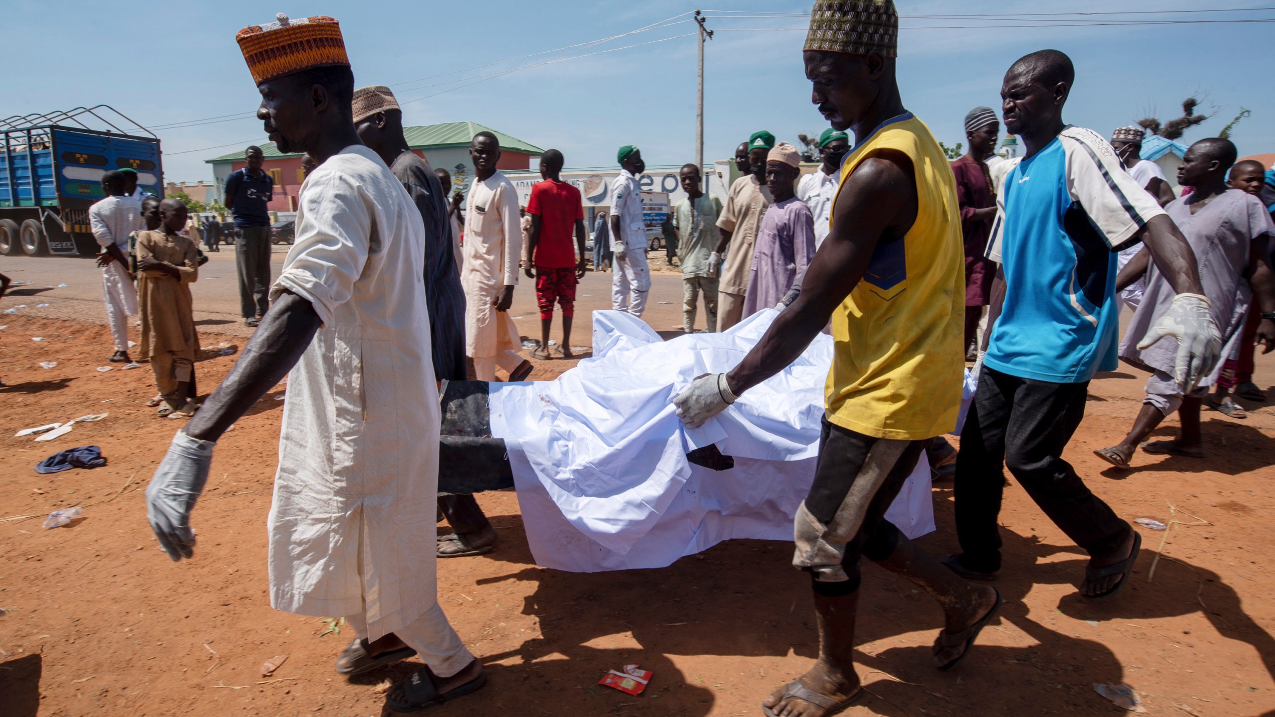 People carry the body of a victim of a tanker explosion for funeral in Majiya town, Nigeria, Wednesday, Oct. 16, 2024. (AP Photo/Sani Maikatanga)