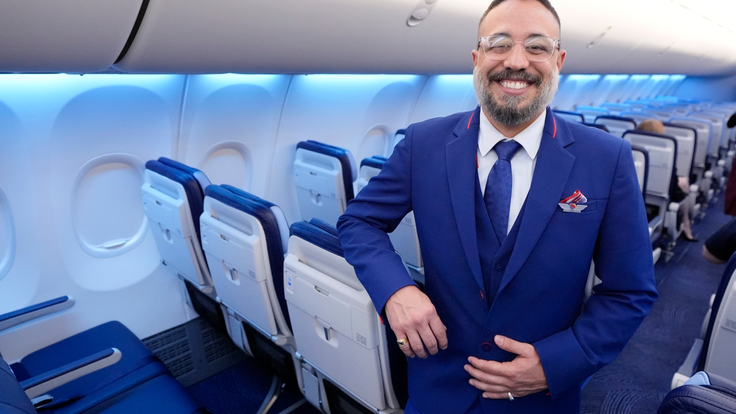 FILE - Ryan Munoz, a flight attendant with Southwest Airlines, poses in the airline's newly designed uniform on Sept. 26, 2024, in Dallas. (AP Photo/Tony Gutierrez, File)