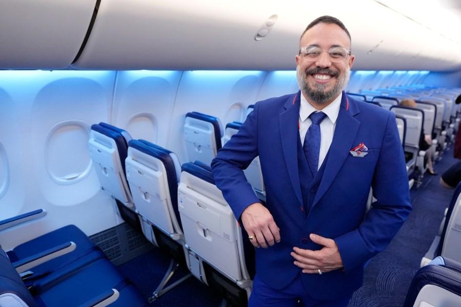 FILE - Ryan Munoz, a flight attendant with Southwest Airlines, poses in the airline's newly designed uniform on Sept. 26, 2024, in Dallas. (AP Photo/Tony Gutierrez, File)