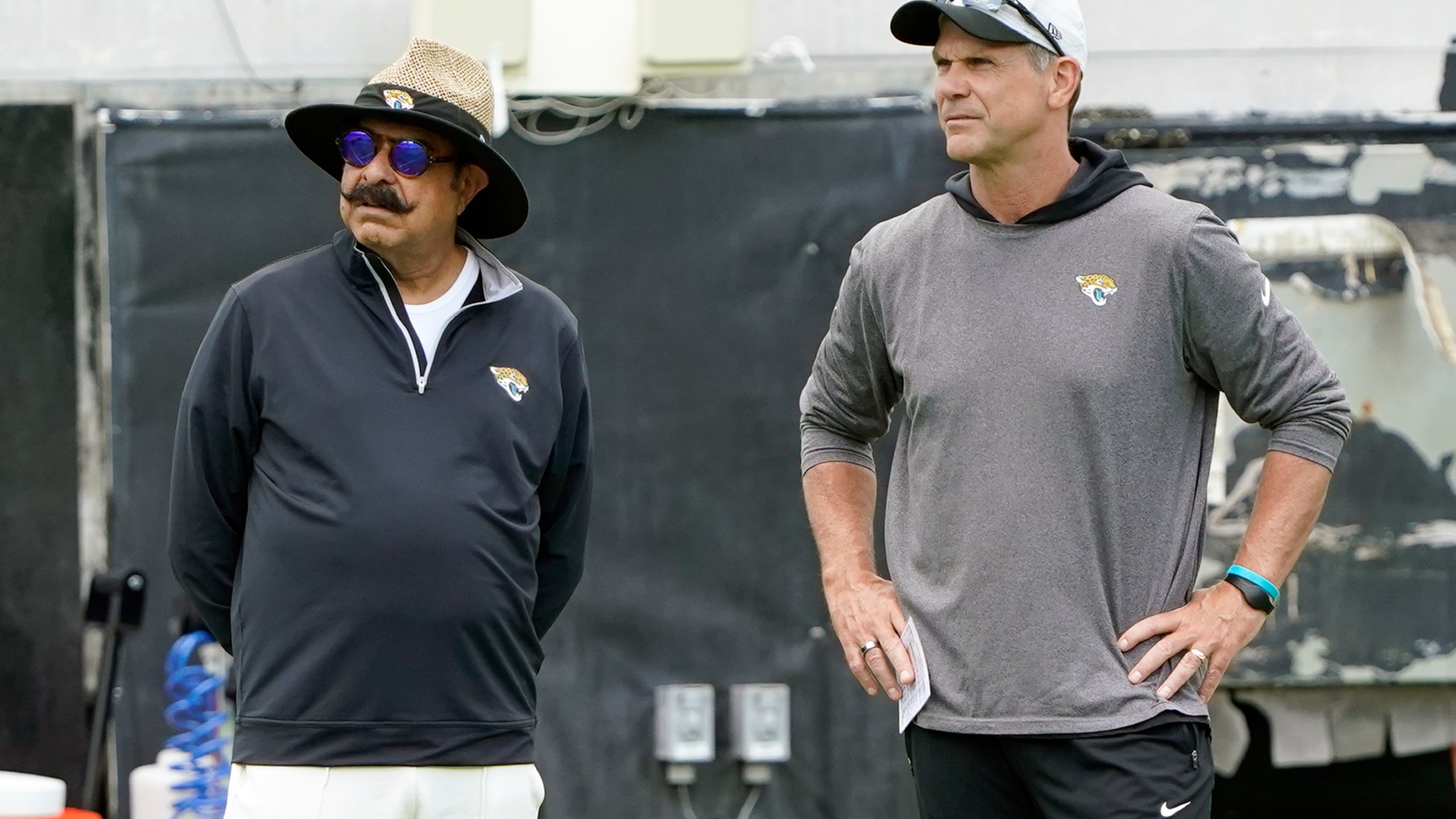 FILE - Jacksonville Jaguars owner Shad Khan, left, and general manager Trent Baalke watch players during the NFL football team's rookie minicamp, Saturday, May 14, 2022, in Jacksonville, Fla. (AP Photo/John Raoux, File)