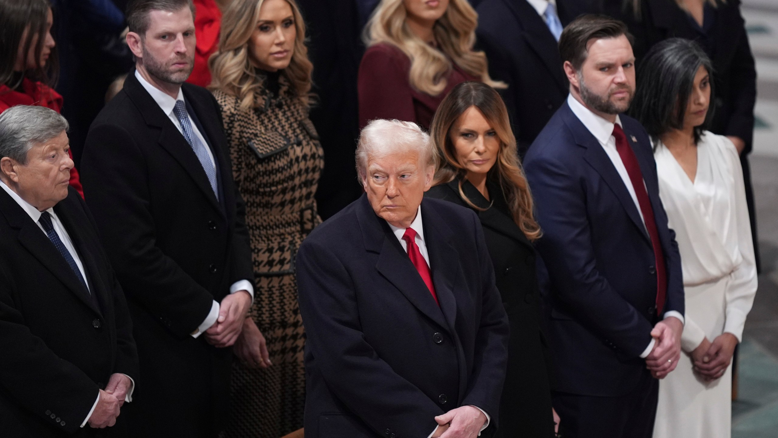 President Donald Trump, from front row left, first lady Melania Trump, Vice President JD Vance, his wife Usha Vance, and from back row left, Viktor Knavs, Eric Trump, Lara Trump and Tiffany Trump attend the national prayer service at the Washington National Cathedral, Tuesday, Jan. 21, 2025, in Washington. (AP Photo/Evan Vucci)