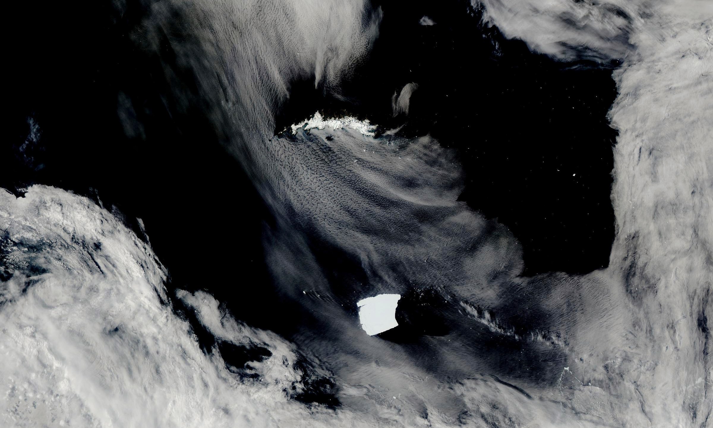 An iceberg seen on NASA’s Aqua satellite, known as A23a, center, is visible as it heads toward South Georgia Island, top, on Jan. 15, 2025, off the coast of Antarctica. (NASA Worldview via AP)