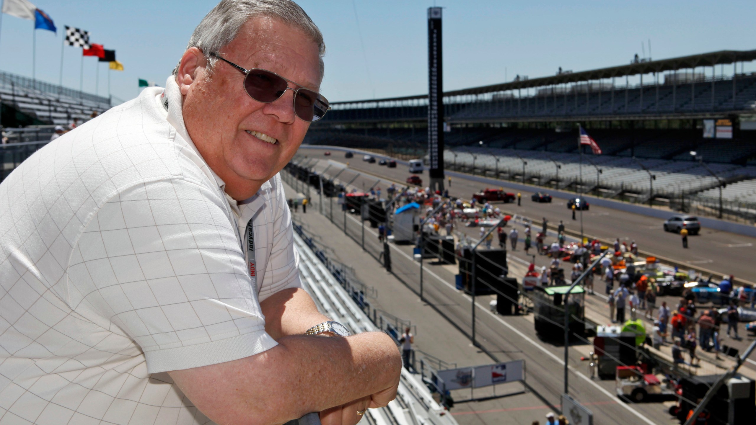 FILE - Associated Press auto racing writer Mike Harris poses along the main straightway at the Indianapolis Motor Speedway in Indianapolis, on Wednesday, May 20, 2009. (AP Photo/Michael Conroy, File)