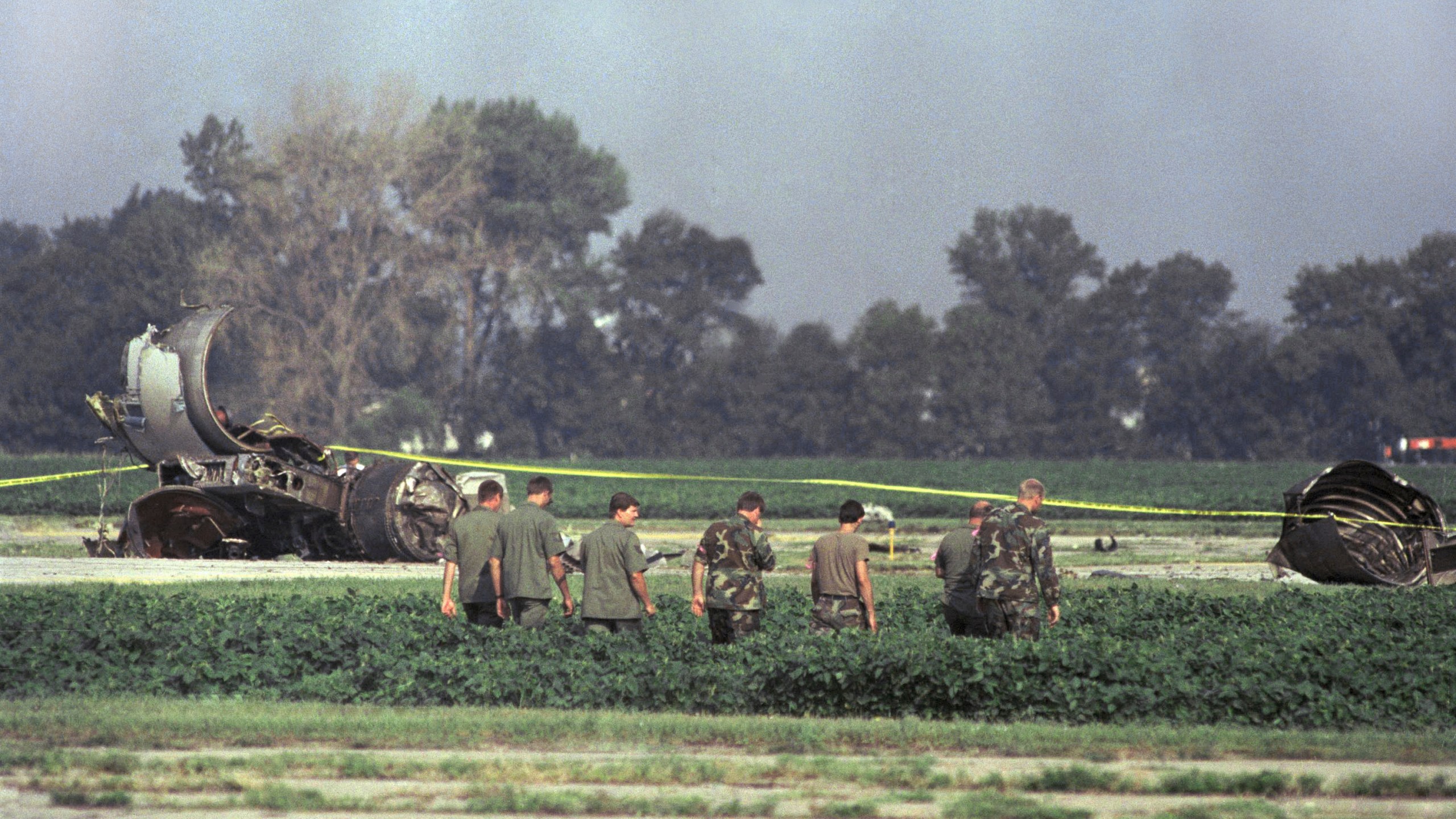 FILE - In this July 20, 1989 file photo Iowa Air National Guard soldiers search a field near the burned engine of United Airlines Flight 232 after the McDonnell Douglas DC-10 carrying nearly 300 people crash landed at the Sioux City, Iowa, airport. (AP Photo/James Finley, File)