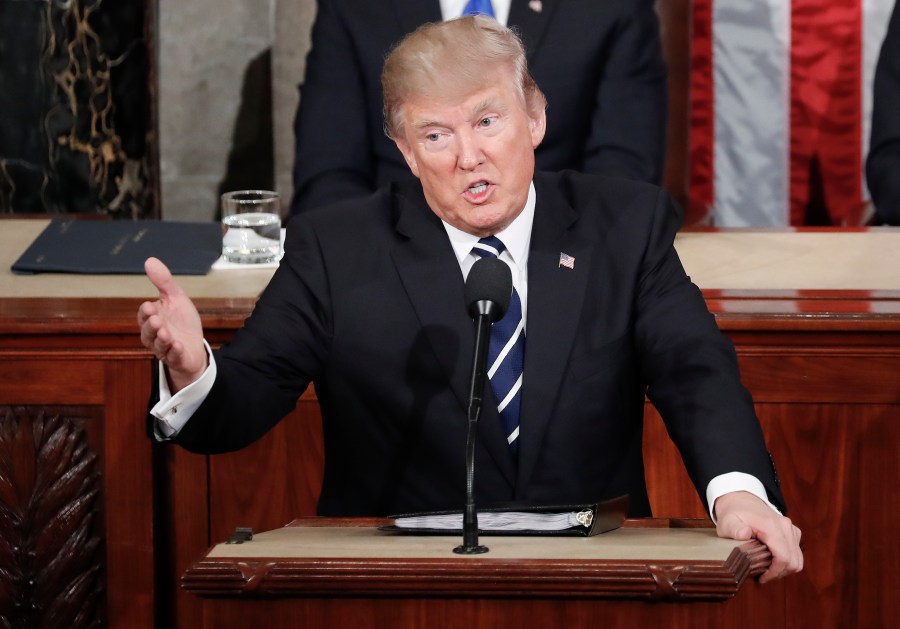 FILE - President Donald Trump gestures towards Democrats while addressing a joint session of Congress at the U.S. Capitol in Washington, Feb. 28, 2017. (AP Photo/Pablo Martinez Monsivais, File)