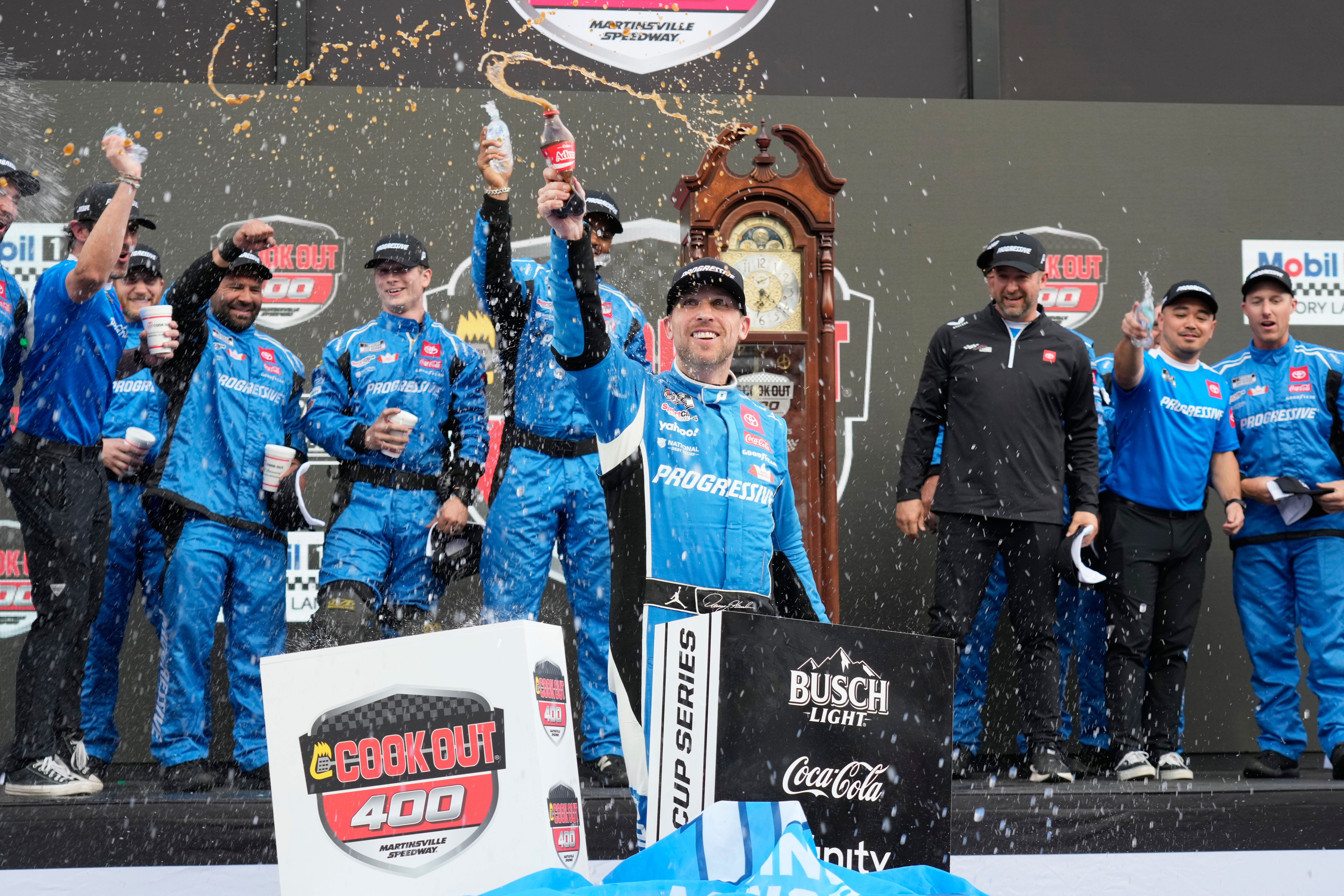 Denny Hamlin celebrates in Victory Lane after winning a NASCAR Cup Series auto race in Martinsville, Va., Sunday, March 30, 2025. (AP Photo/Chuck Burton)