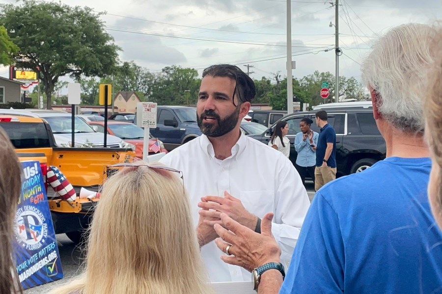 Josh Weil talks to a group of supporters during a Get Out the Vote event in Ocala, Fla., Monday, March 31, 2025. (AP Photo/Stephany Matat)