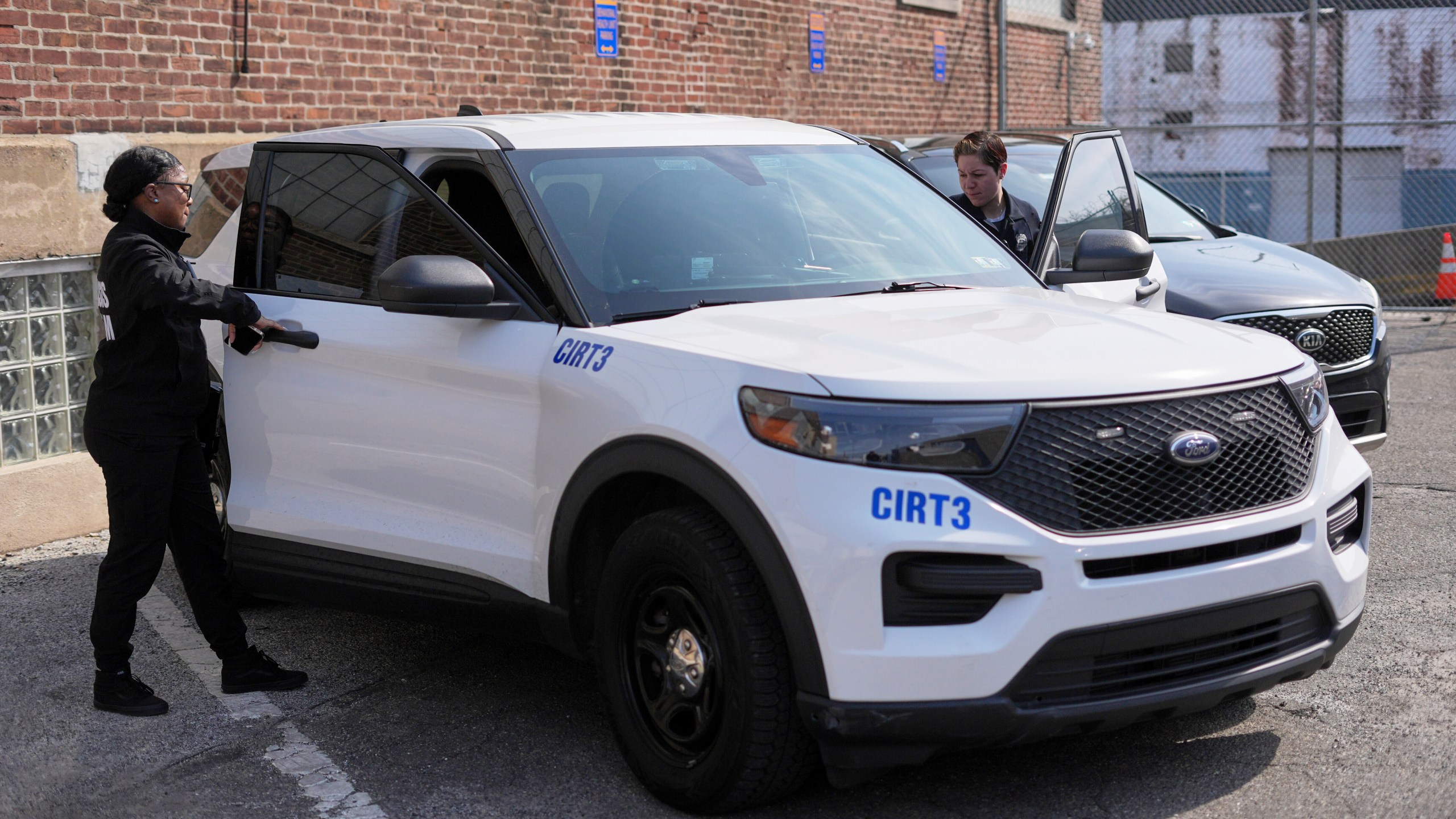 Crisis Intervention Response Team (CIRT) members Therapist Krystian Gardner, left, and Philadelphia Police Officer Vanity Cordero prepare to go out on calls in Philadelphia, Friday, March 14, 2025. (AP Photo/Matt Rourke)