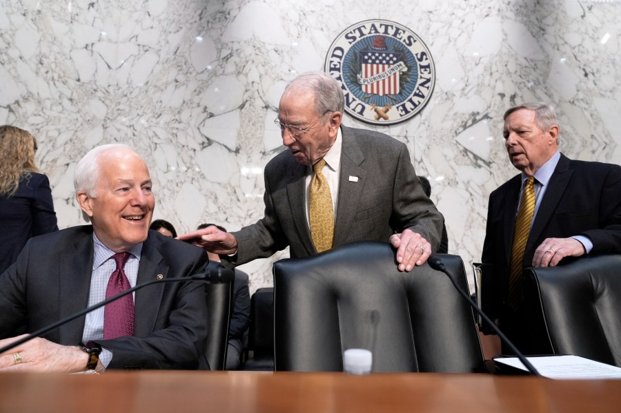 Senate Judiciary Committee Chairman Chuck Grassley, R- Iowa, center, greets Sen. John Cornyn, R-Texas, left, while Sen. Dick Durbin, D-Ill., arrives at right as the panel meets to consider prescription drug pricing and other measures, at the Capitol in Washington, Thursday, April 3, 2025. (AP Photo/J. Scott Applewhite)
