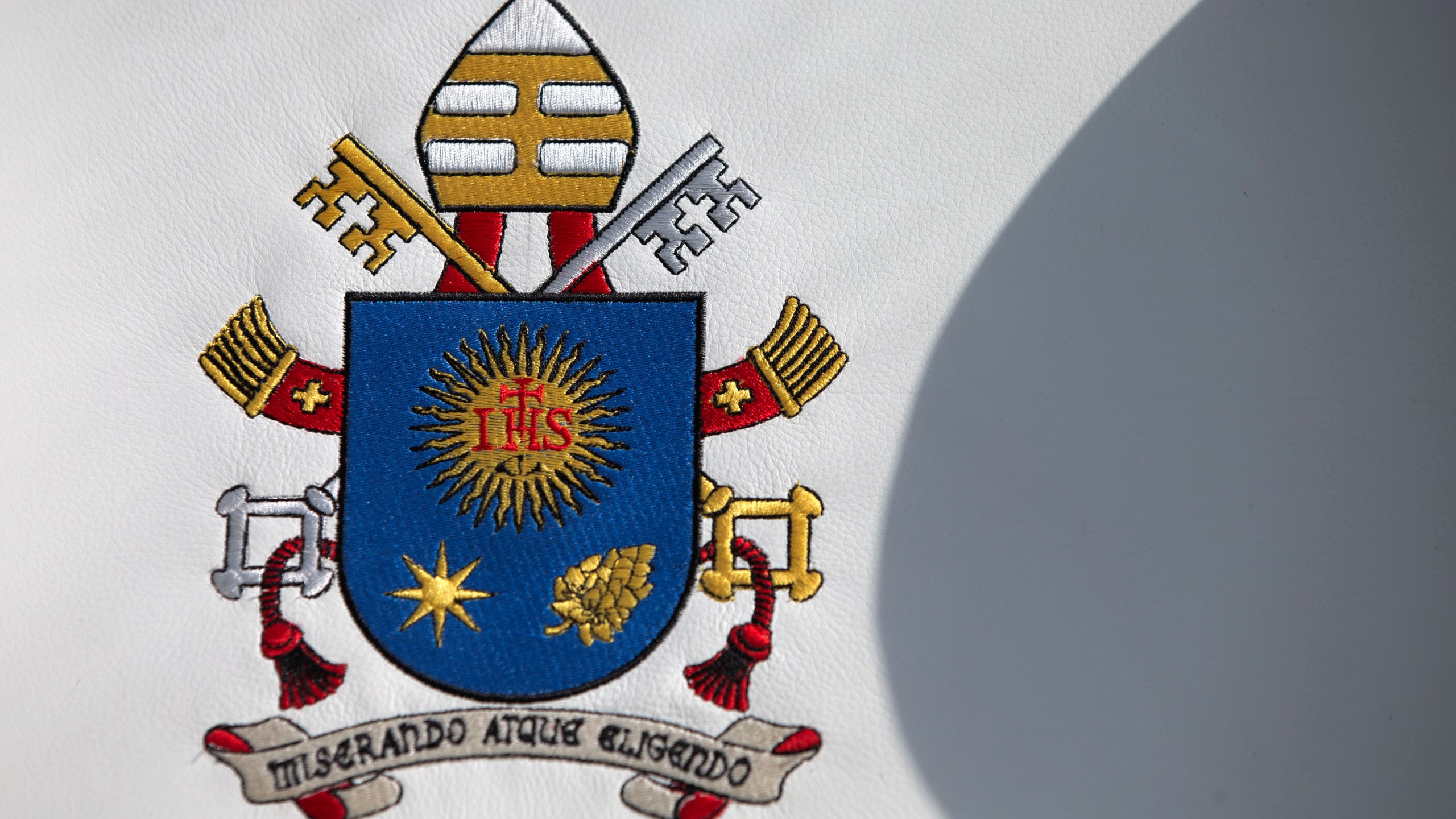 FILE - Pope Francis's coat of arms adorns the seat of a popemobile that will be used during his upcoming visit to Mexico, inside the presidential hangar at Mexico City's airport, Monday, Feb. 8, 2016. (AP Photo/Rebecca Blackwell, file)