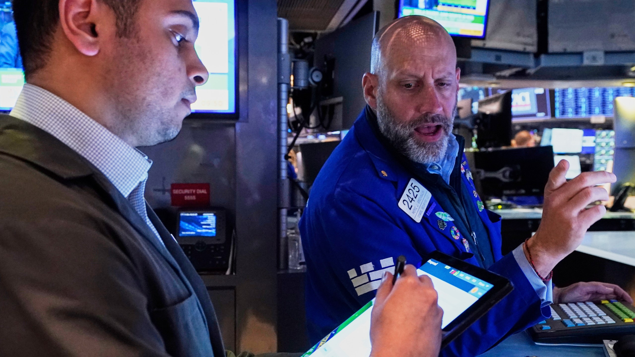 Trader Niall Pawa, left, and Specialist Meric Greenbaum work on the floor of the New York Stock Exchange, Wednesday, April 23, 2025. (AP Photo/Richard Drew)