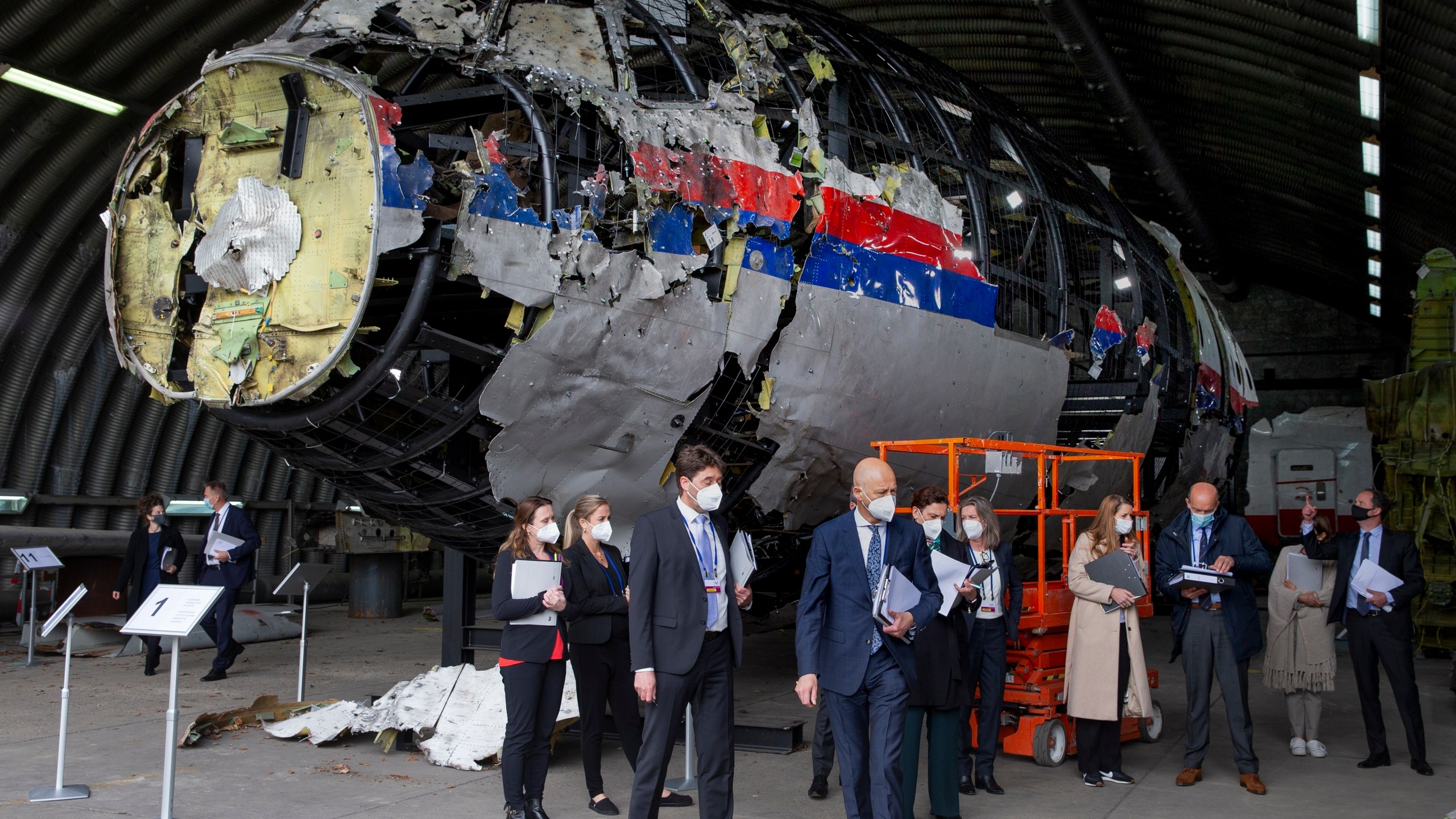 FILE - Judges and lawyers view the wreckage of a Malaysia Airlines passenger jet at the Gilze-Rijen Air Base, Netherlands, on May 26, 2021. (AP Photo/Peter Dejong, Pool, File)