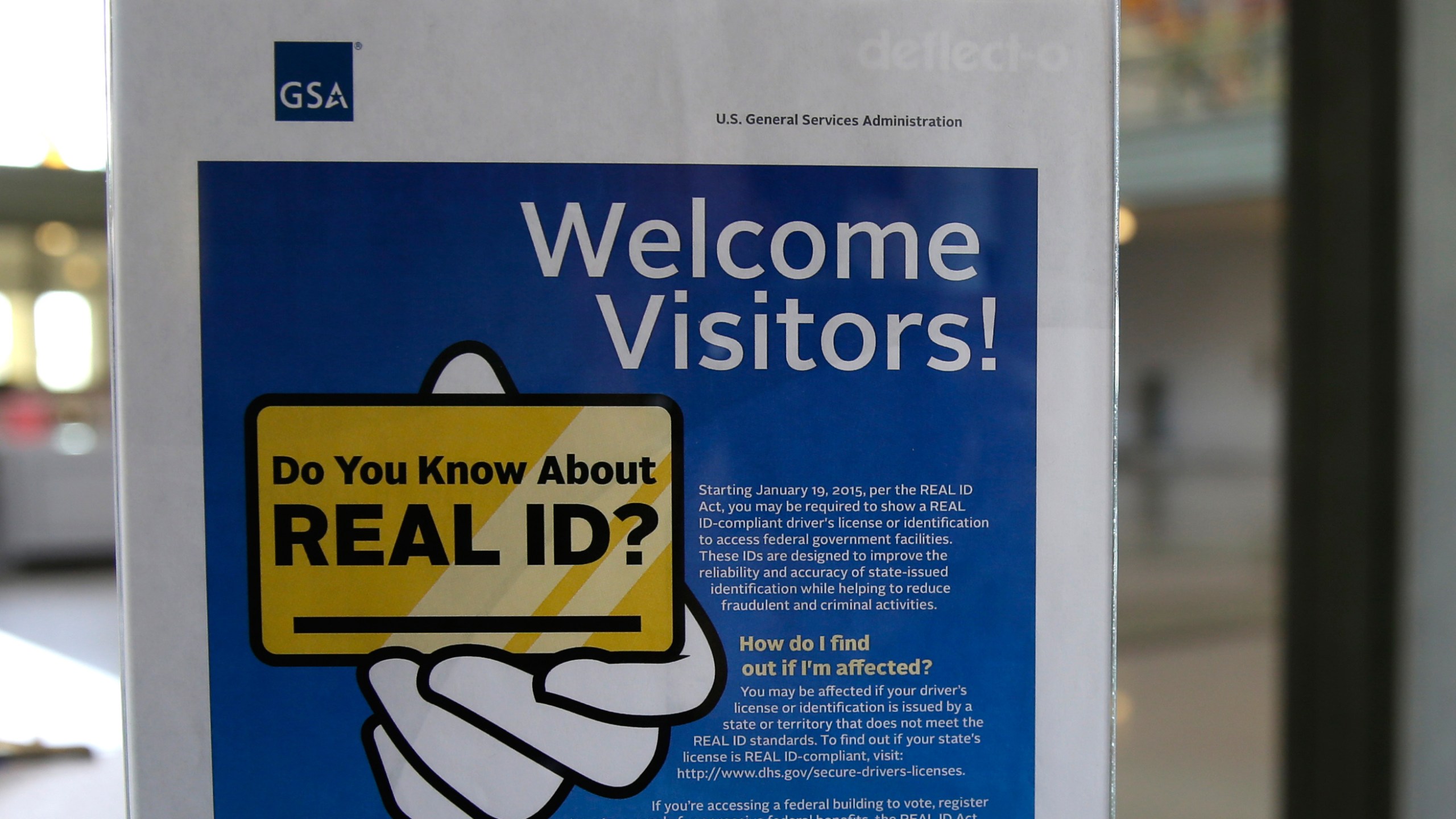 FILE - In this photo taken April 6, 2016, a sign at the federal courthouse in Tacoma, Wash., is shown to inform visitors of the federal government's REAL ID act. (AP Photo/Ted S. Warren, file)
