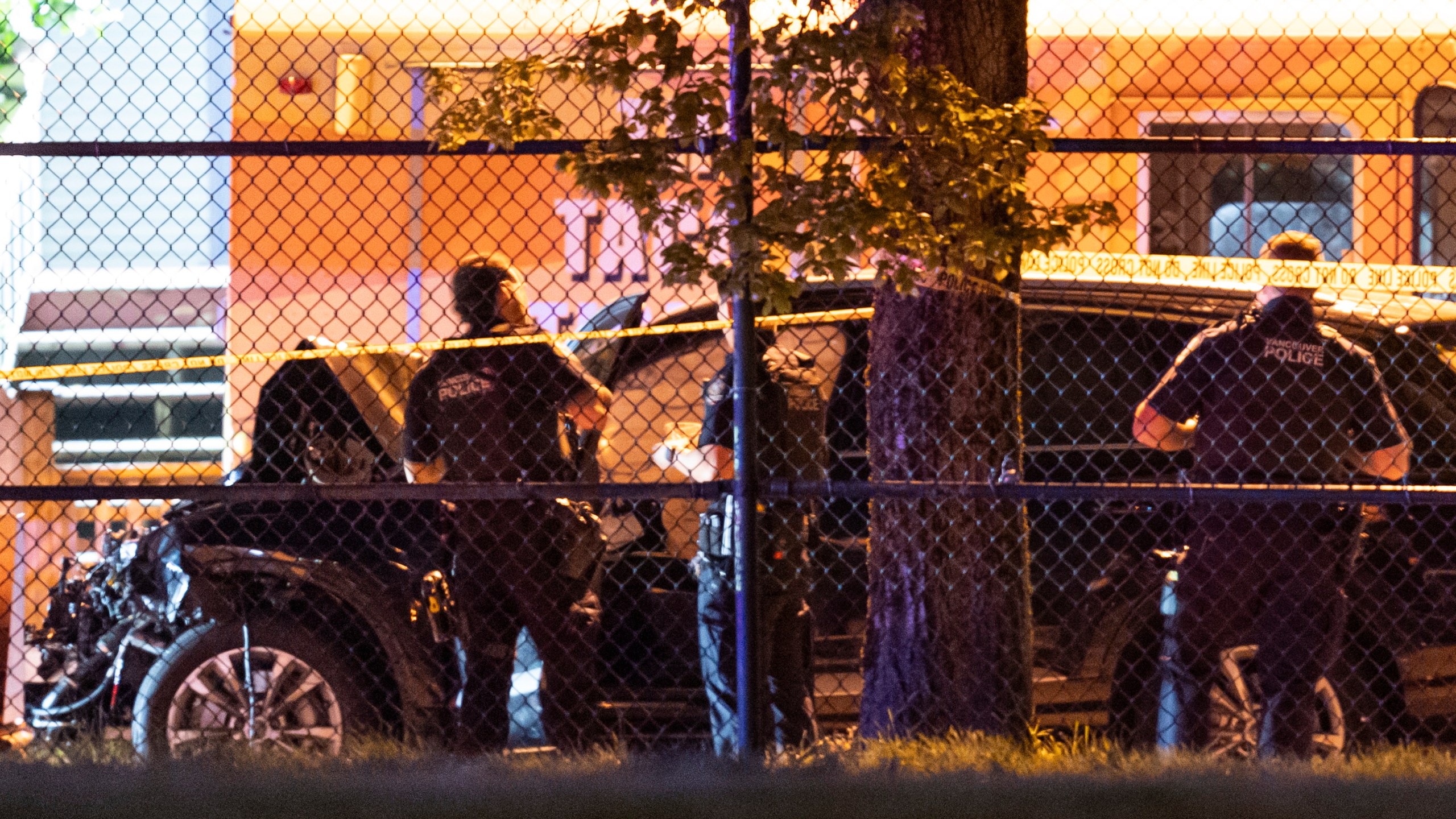 Vancouver police examine a black car suspected to be involved at a scene after a vehicle drove into a crowd at the Lapu Lapu Festival in Vancouver, British Columbia, Saturday April 26, 2025. (Rich Lam/The Canadian Press via AP)