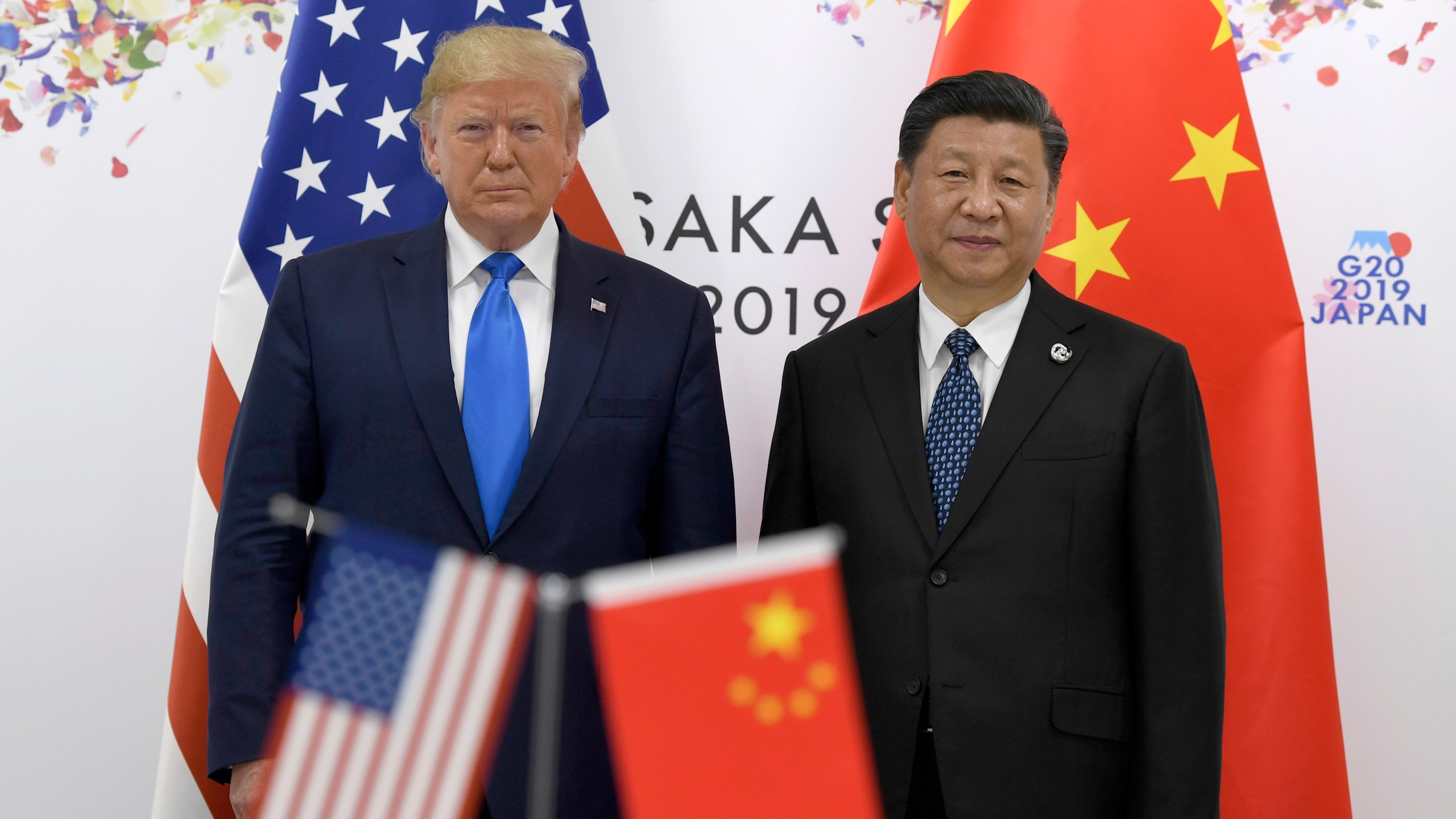 FILE - President Donald Trump, left, poses for a photo with Chinese President Xi Jinping during a meeting on the sidelines of the G-20 summit in Osaka, Japan, June 29, 2019. (AP Photo/Susan Walsh, File)