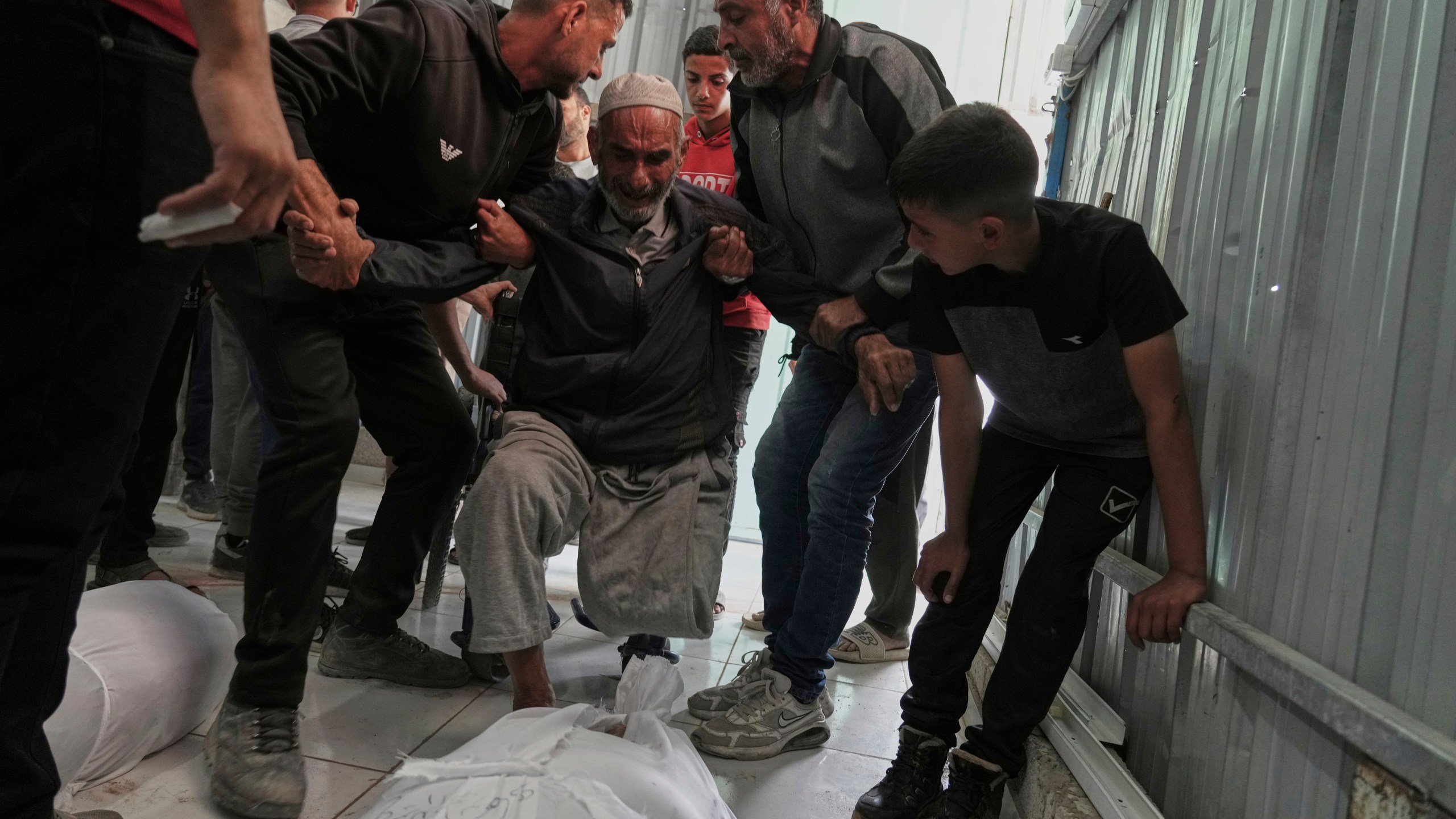 Relatives mourn over the bodies of several members of the Abu Mahdi family, killed in an Israeli army airstrike, during their funeral at the Indonesian hospital in Beit Lahia, northern Gaza Strip, Monday, April 28, 2025. (AP Photo/Jehad Alshrafi)