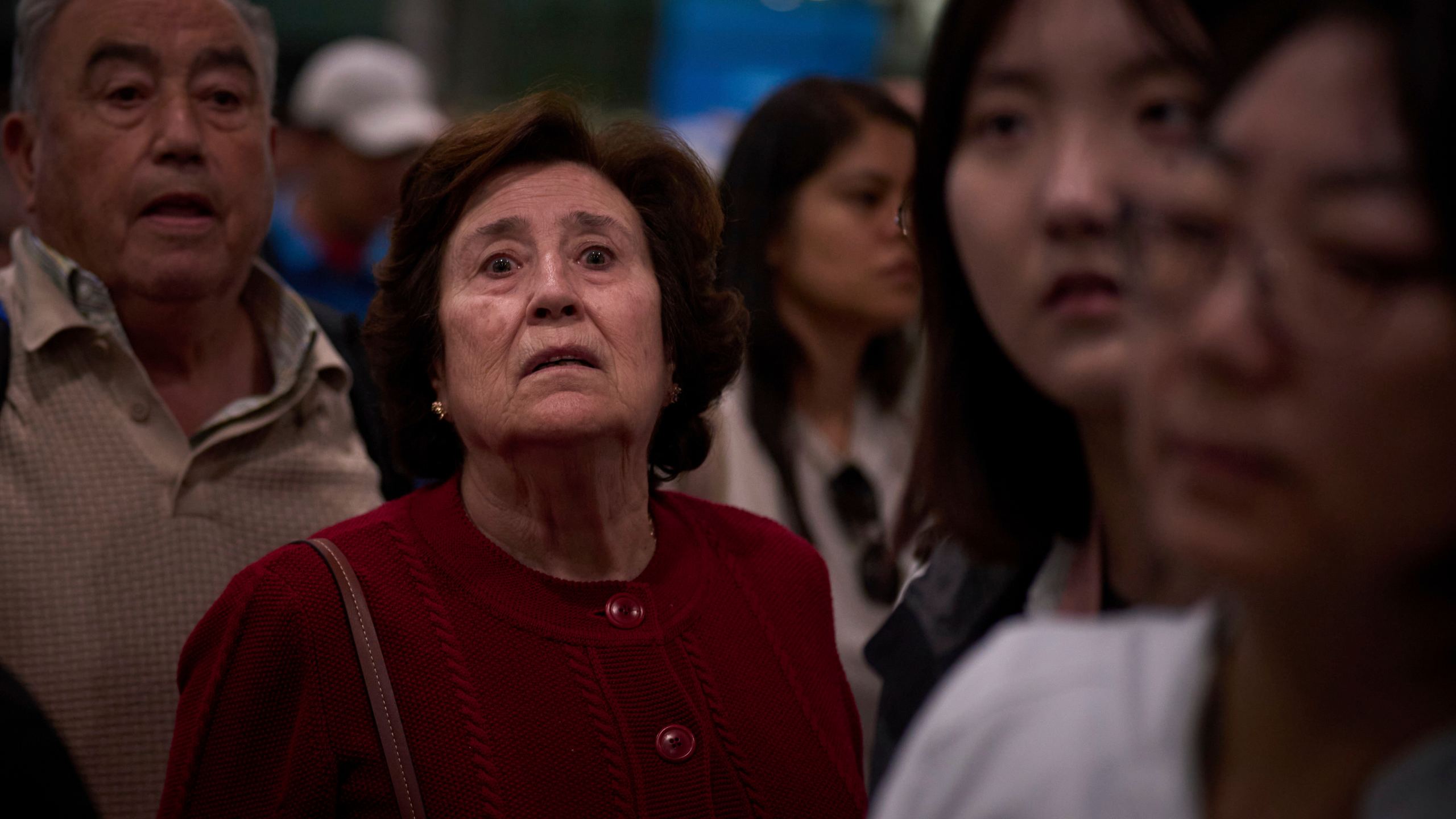 Passengers react as they wait for news of train departures, at Sants train station in Barcelona, Spain, Tuesday, April 29, 2025. (AP Photo/Emilio Morenatti)