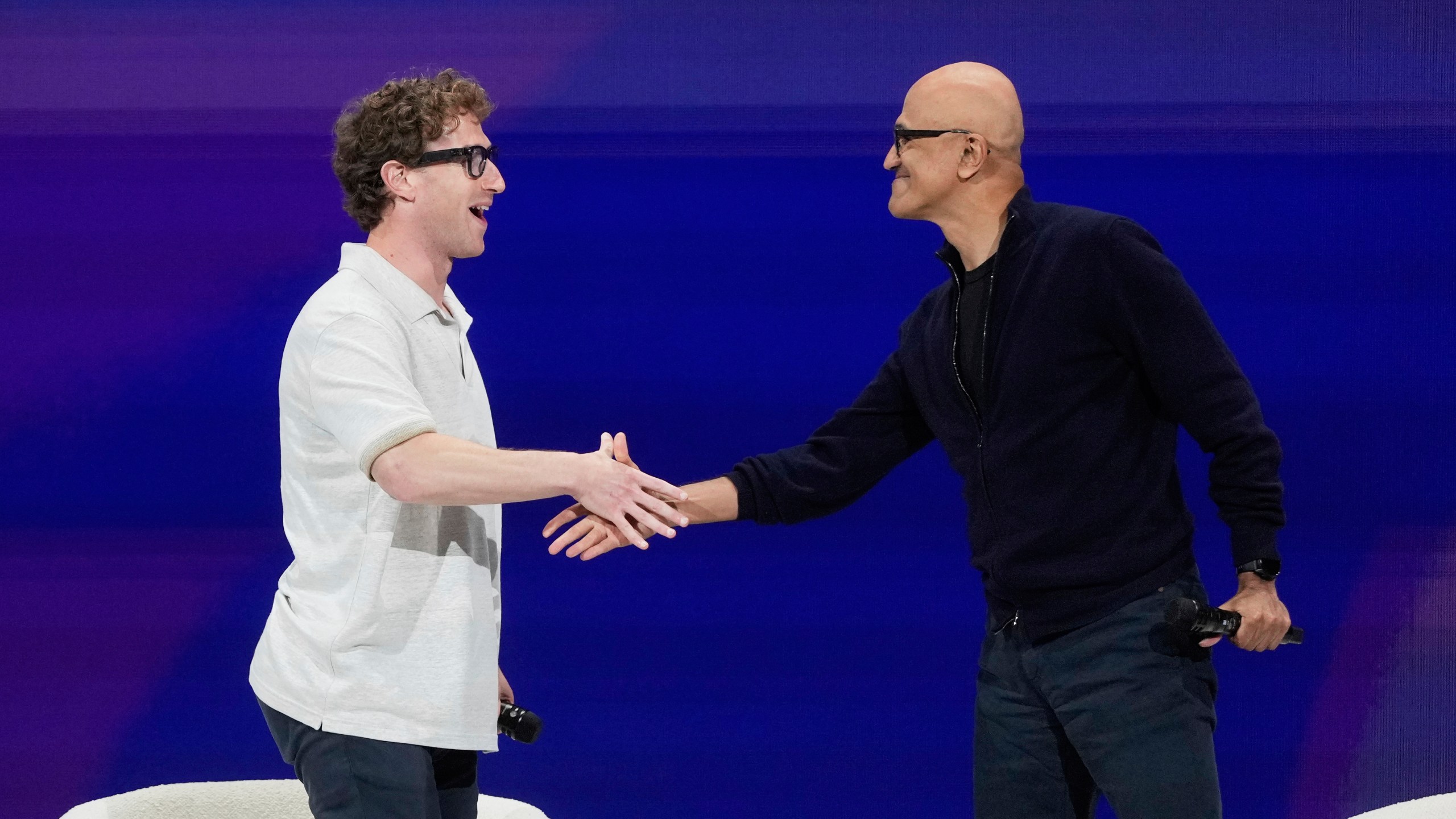 Meta Founder and CEO Mark Zuckerberg, left, shakes hands with Microsoft Chairman and CEO Satya Nadella at LlamaCon 2025, an AI developer conference, in Menlo Park, Calif., Tuesday, April 29, 2025. (AP Photo/Jeff Chiu)