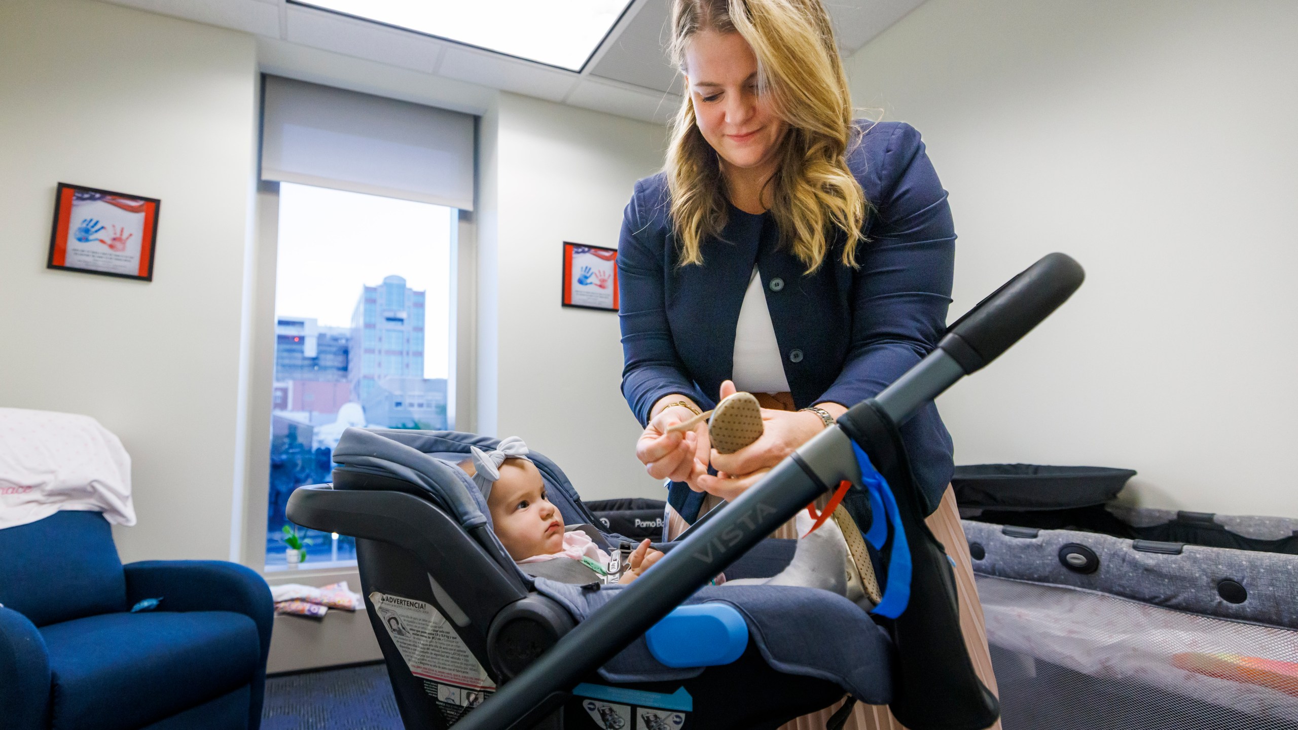 Florida Rep. Fiona McFarland, R-Sarasota, adjusts the shoe of her 7-month-old daughter Grace Melton as she starts her work day at the state Capitol, Thursday, April 17, 2025, in Tallahassee, Fla. (AP Photo/Colin Hackley)