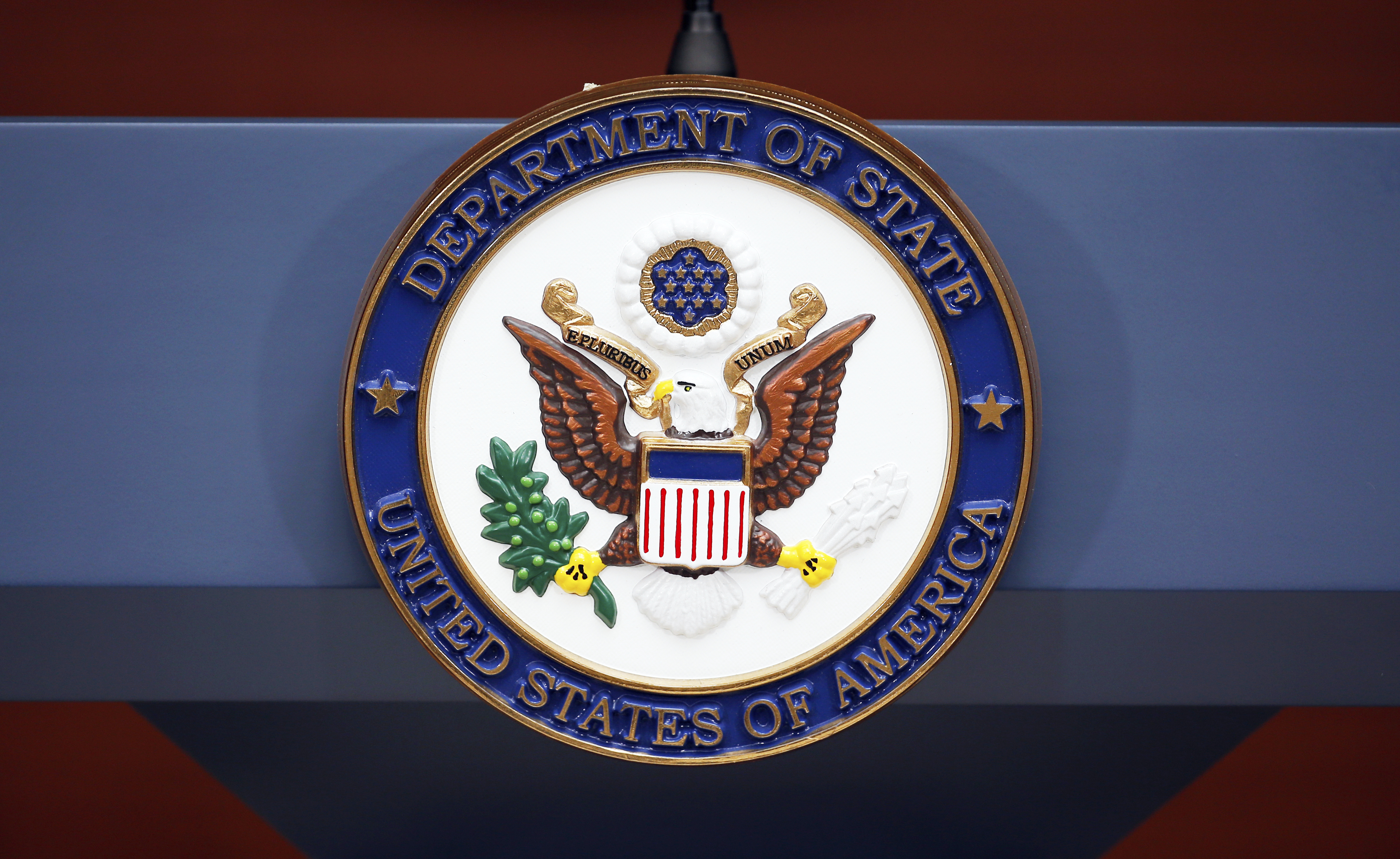 FILE - The seal of the State Department is seen at the Washington Passport Agency, July 12, 2016, in Washington. (AP Photo/Alex Brandon, File)