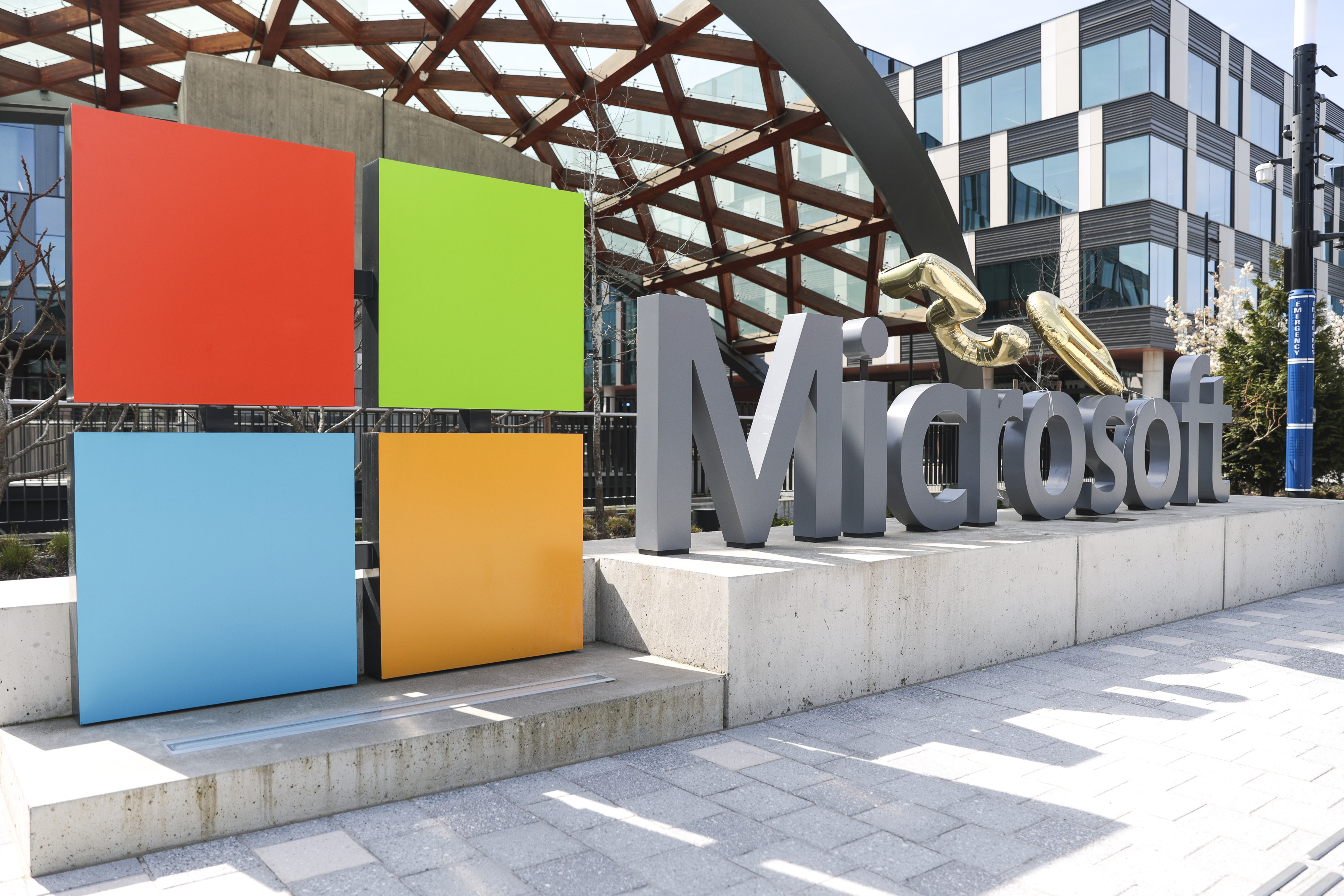 A Microsoft sign and logo are pictured at the company's headquarters, Friday, April 4, 2025, in Redmond, Wash. (AP Photo/Jason Redmond)