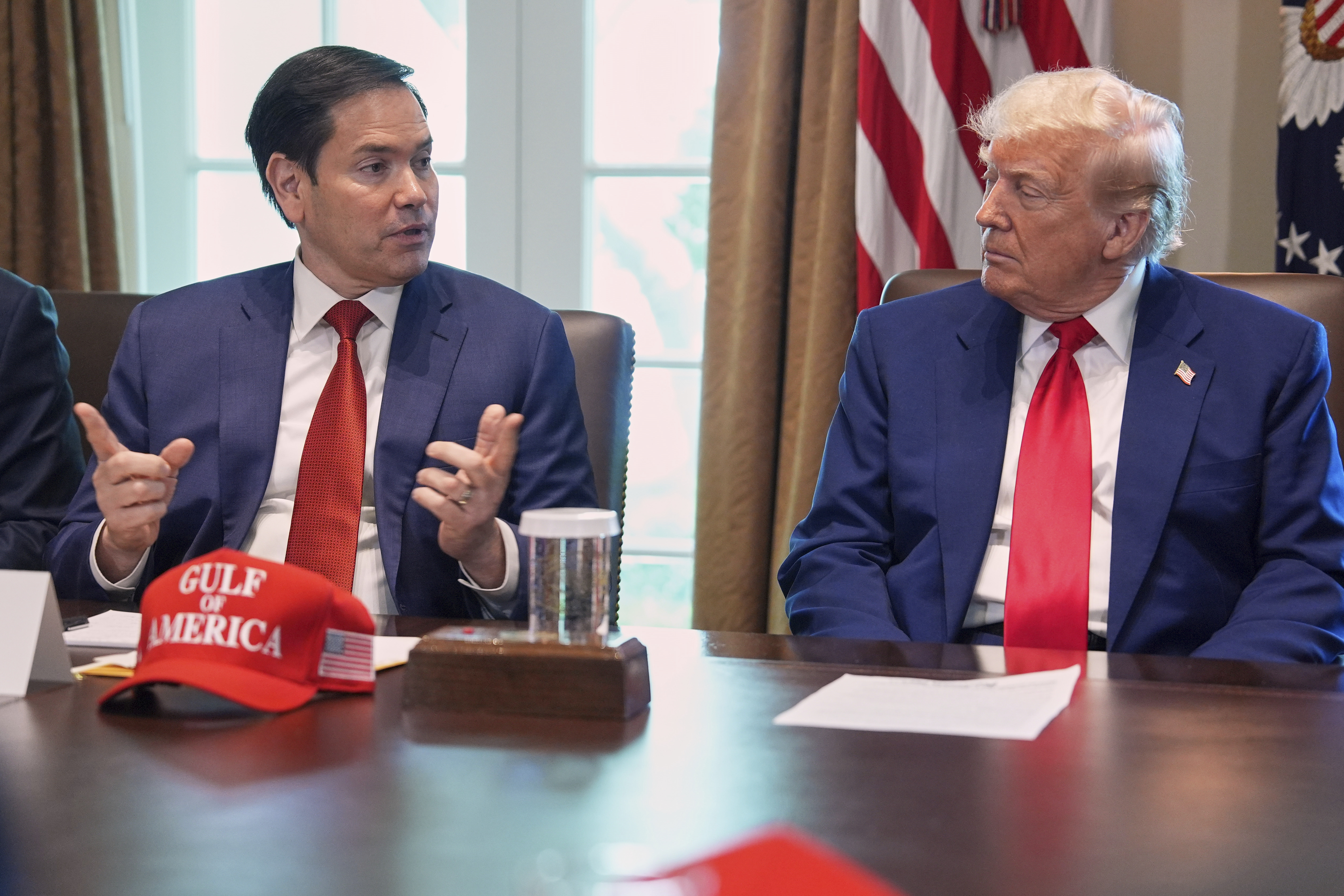Secretary of State Marco Rubio speaks during a cabinet meeting at the White House, Wednesday, April 30, 2025, in Washington, as President Donald Trump look on. (AP Photo/Evan Vucci)