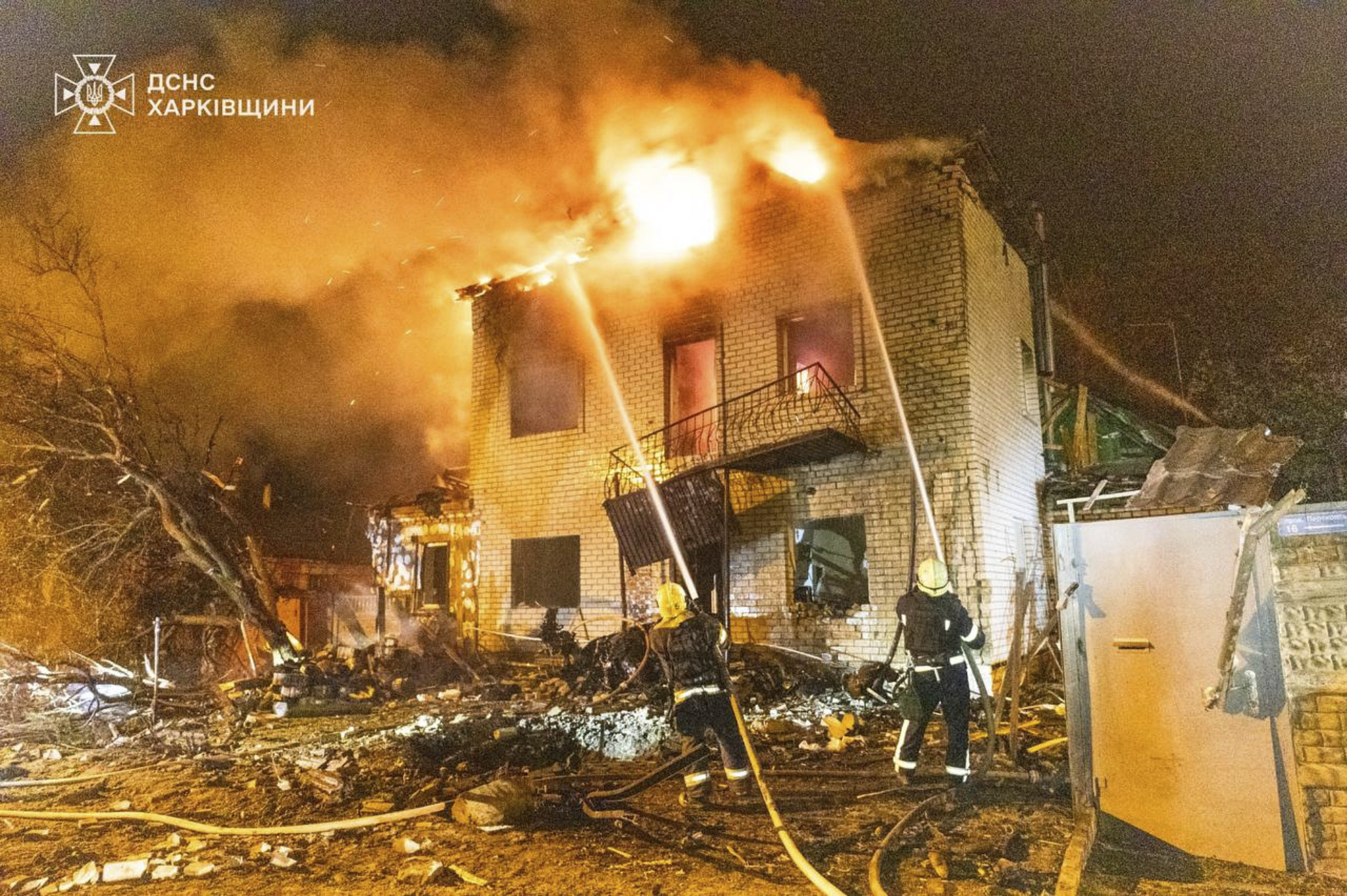 In this photo provided by the Ukrainian Emergency Service, emergency services personnel work to extinguish a fire following a Russian attack in Kharkiv, Ukraine, Wednesday, April 30, 2025. (Ukrainian Emergency Service via AP)