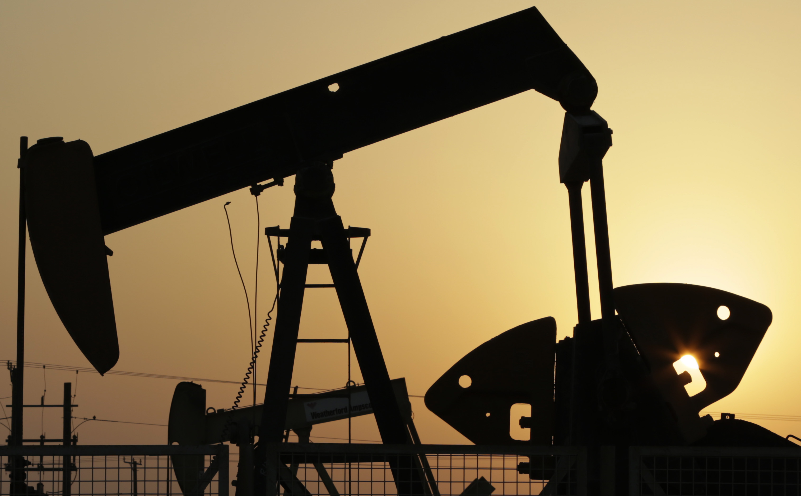 FILE - Oil pumps work in the desert oil fields of Sakhir, Bahrain, Sept. 30, 2015. (AP Photo/Hasan Jamali, File)