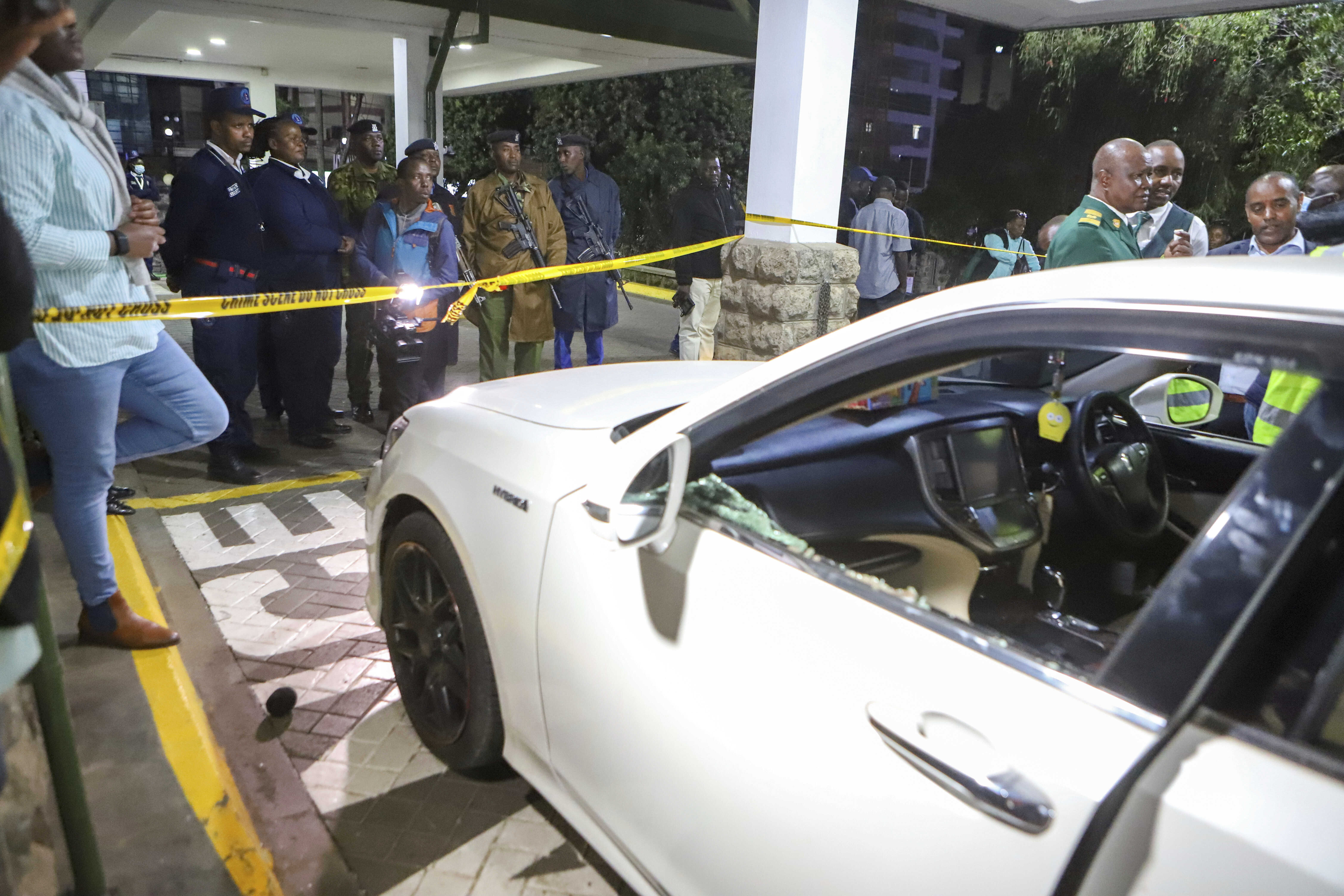 Crime scene unit investigators and Kenya Police detectives inspect a vehicle in which Kenyan MP Charles Ong'ondo Were was shot dead on Wednesday, April 30, 2025 night after his car stopped at a roundabout on a busy major road in the capital Nairobi. (AP Photo/Andrew Kasuku)
