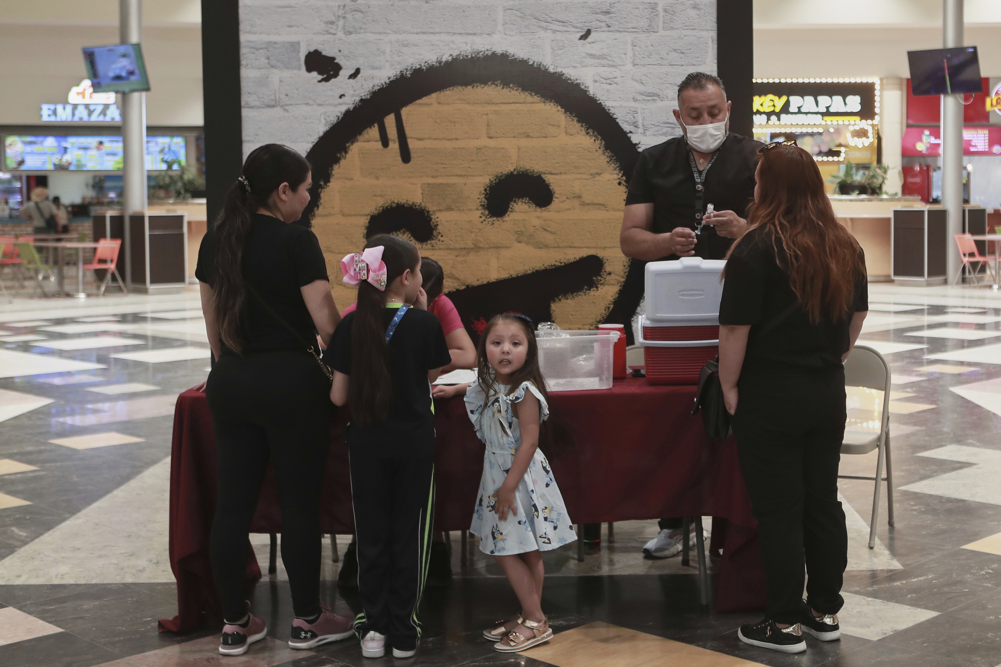 A health worker prepares a dose of the measles vaccine in shopping mall in Ciudad Juarez, Chihuahua state, Mexico, Wednesday, April 30, 2025. (AP Photo/Christian Chavez)