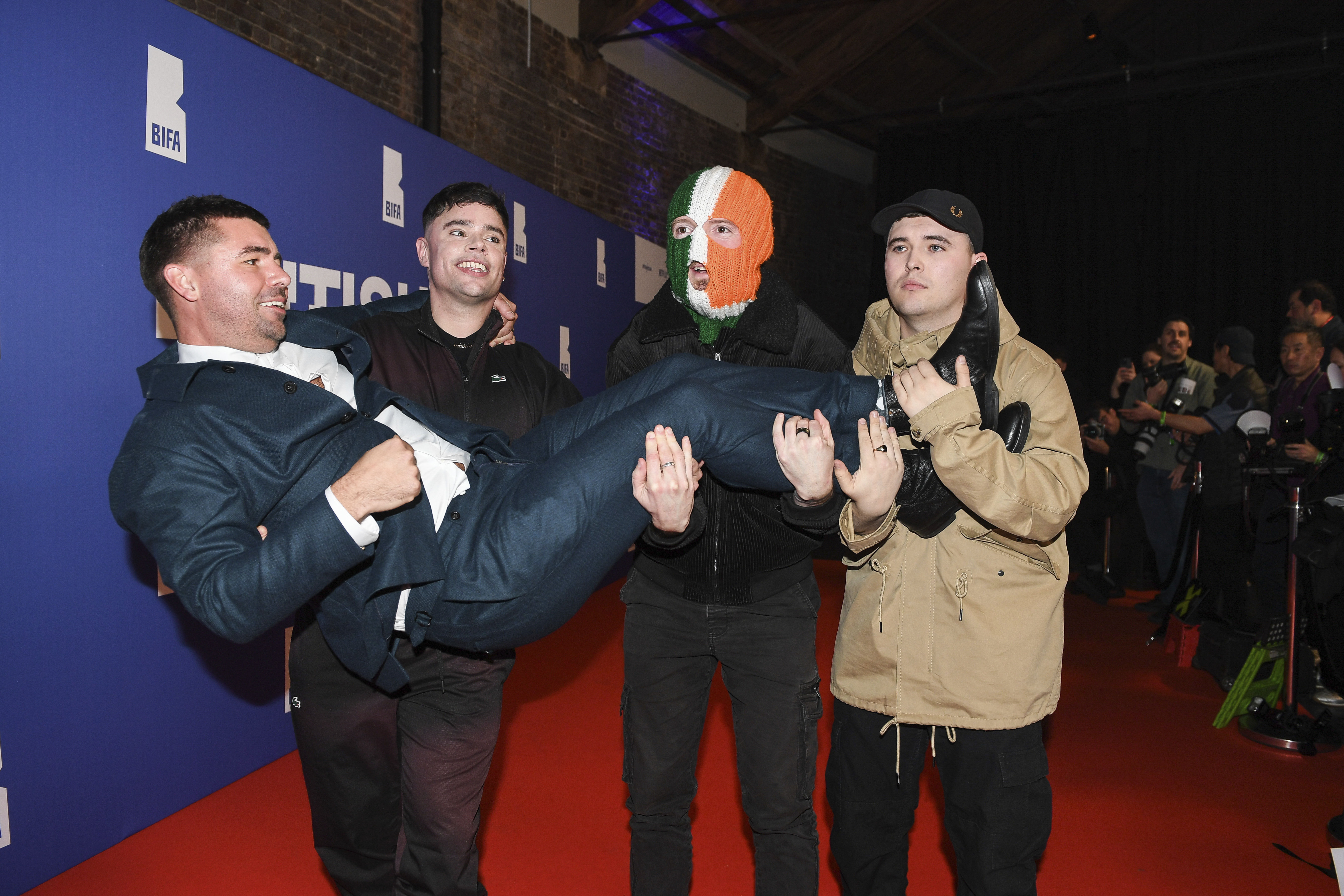 FILE - Rich Peppiatt, Naoise ó Cairealláin, DJ Provaí and Mo Chara of Kneecap pose on arrival at the Britain Independent Film Awards on Sunday, Dec. 8, 2024, in London. (Photo by Thomas Krych/Invision/AP, File)