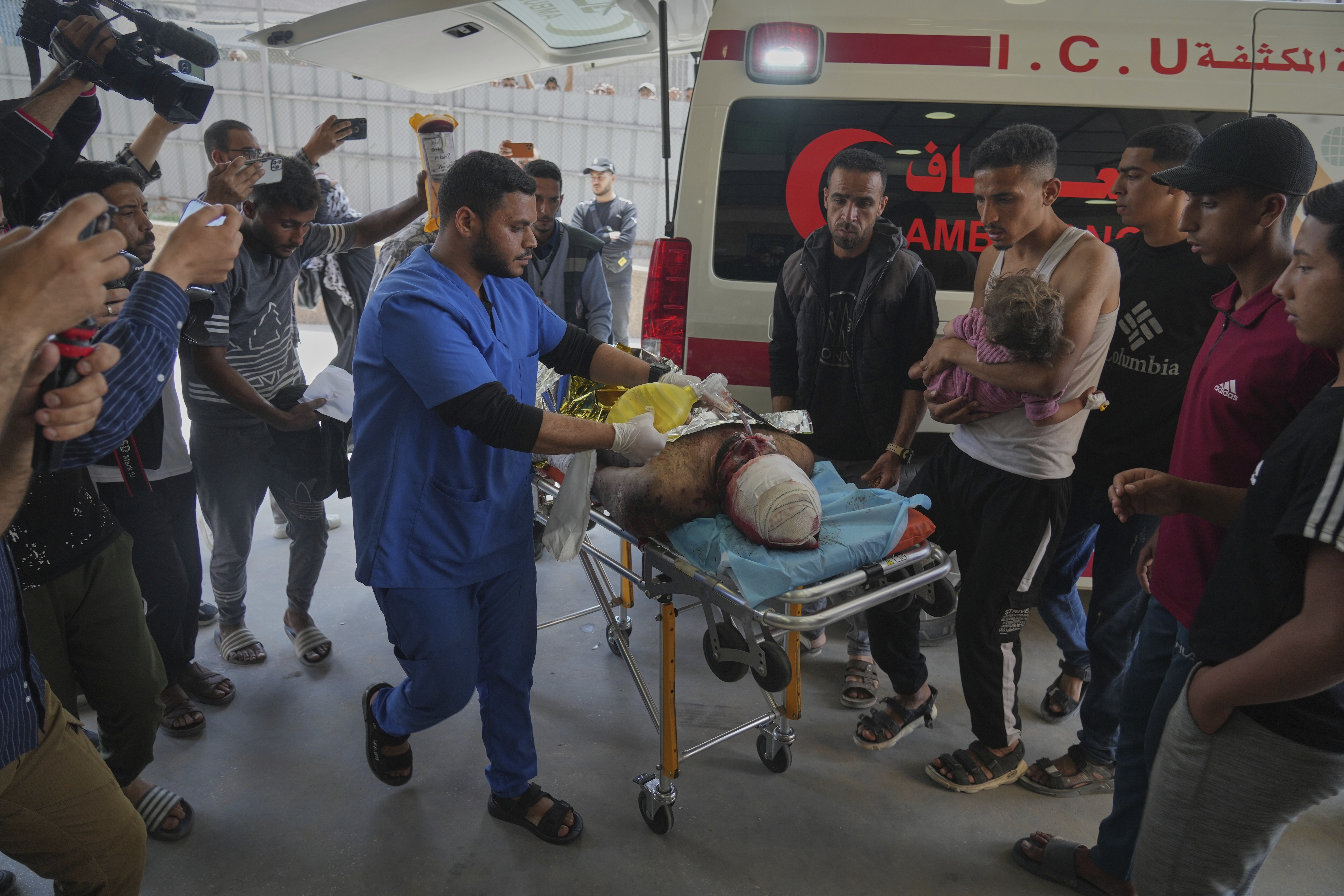 A wounded man and a child are taken into the Nasser hospital after an Israeli army strike hit a house killing at least five members of the Abu Sahloul family, in Khan Younis, in the southern Gaza Strip, Thursday, May 1, 2025. (AP Photo/Abdel Kareem Hana)