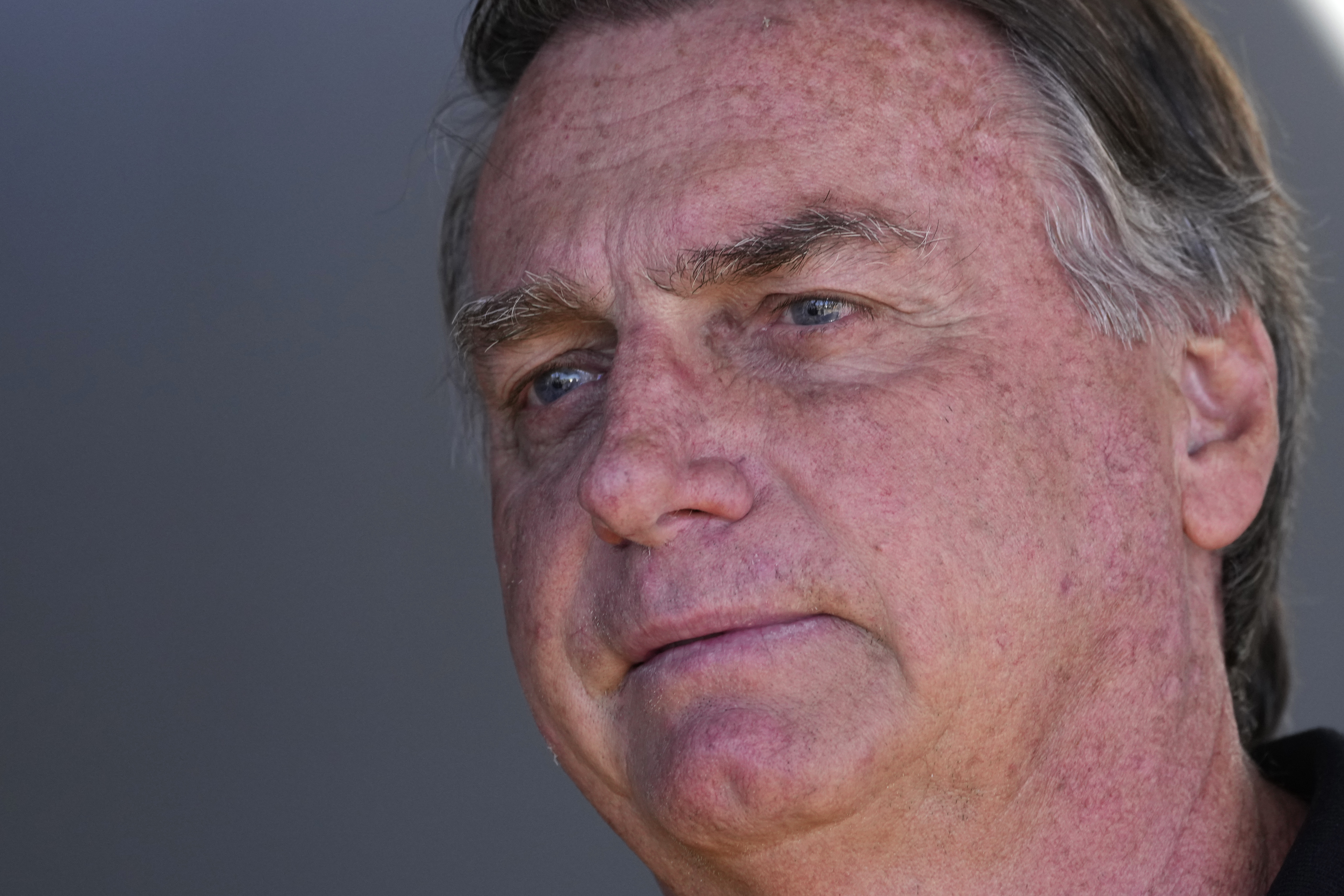 FILE - Former Brazilian President Jair Bolsonaro talks with supporters during his arrival to the international airport in Brasilia, Brazil, July 5, 2024. (AP Photo/Eraldo Peres, File)