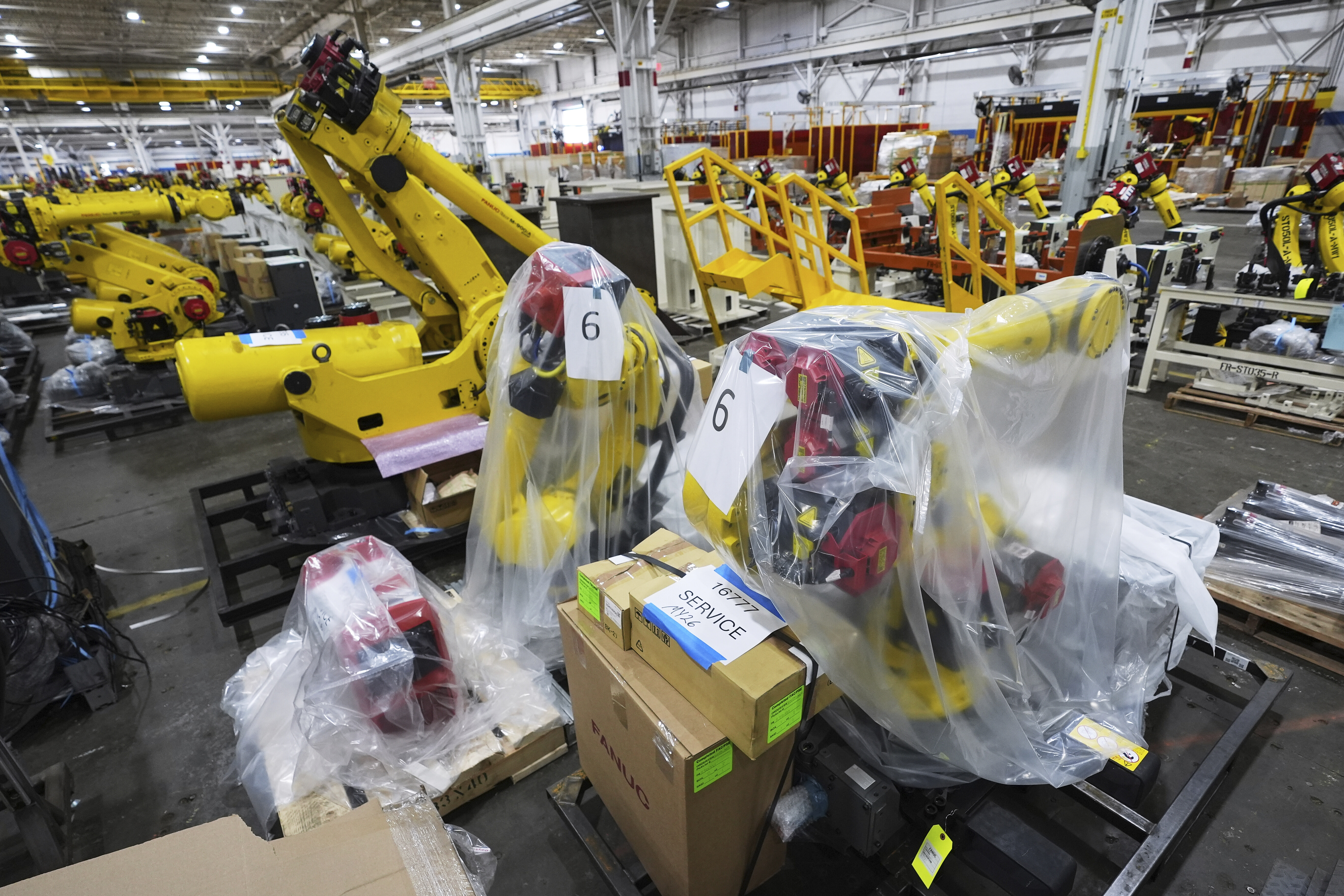 Robotic arms are shown stored at a Paslin facility Wednesday, April 23, 2025, in Warren, Mich. (AP Photo/Paul Sancya)