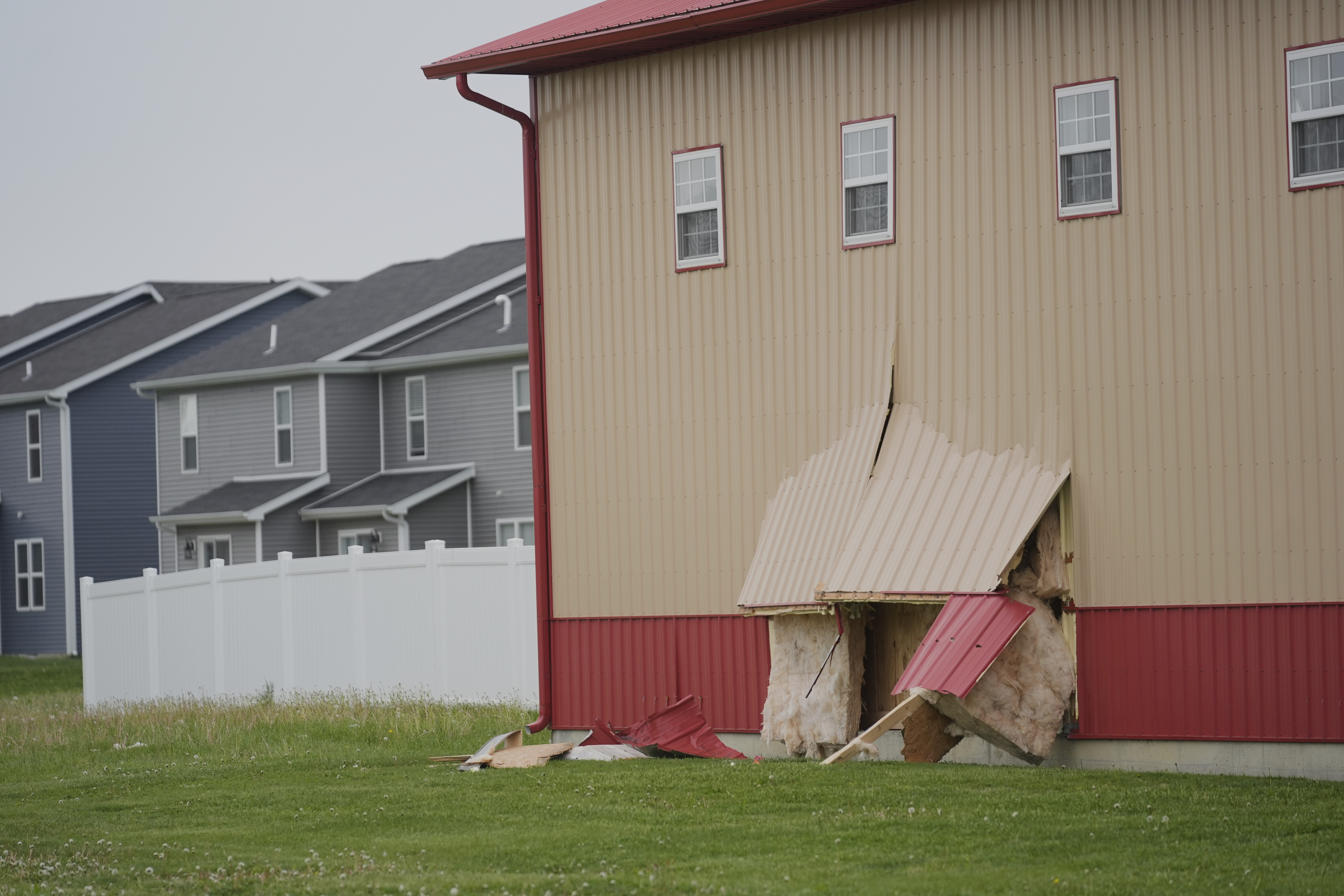 Damage is visible at the scene after a car barreled through a building used for an after-school camp Tuesday, April 29, 2025, in Chatham, Ill. (AP Photo/Erin Hooley)