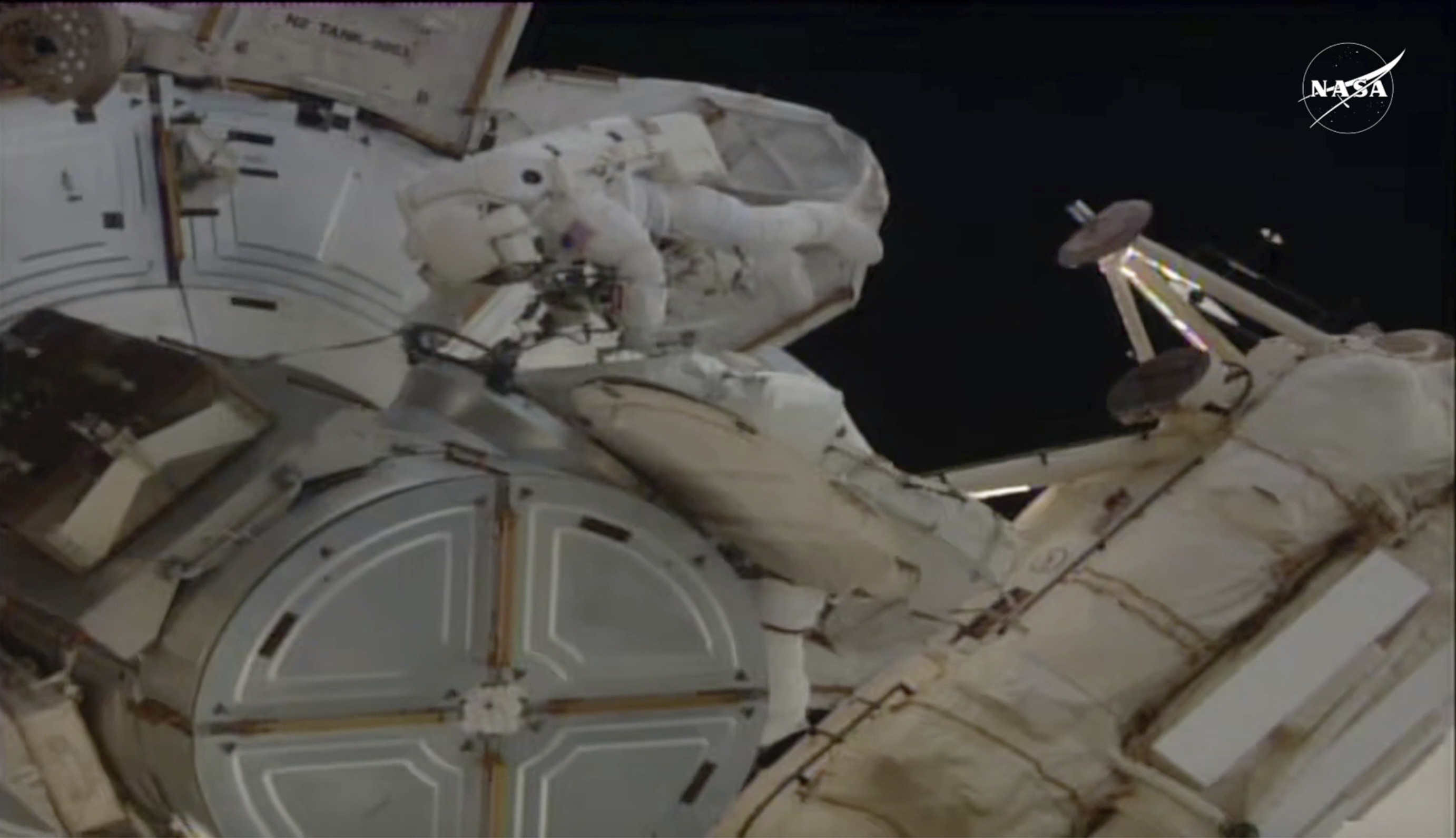 In this image provided by NASA, astronauts Anne McClain and Nichole Ayers work outside the International Space Station during a spacewalk, Thursday, May 1, 2025. (AP Photo/NASA TV)