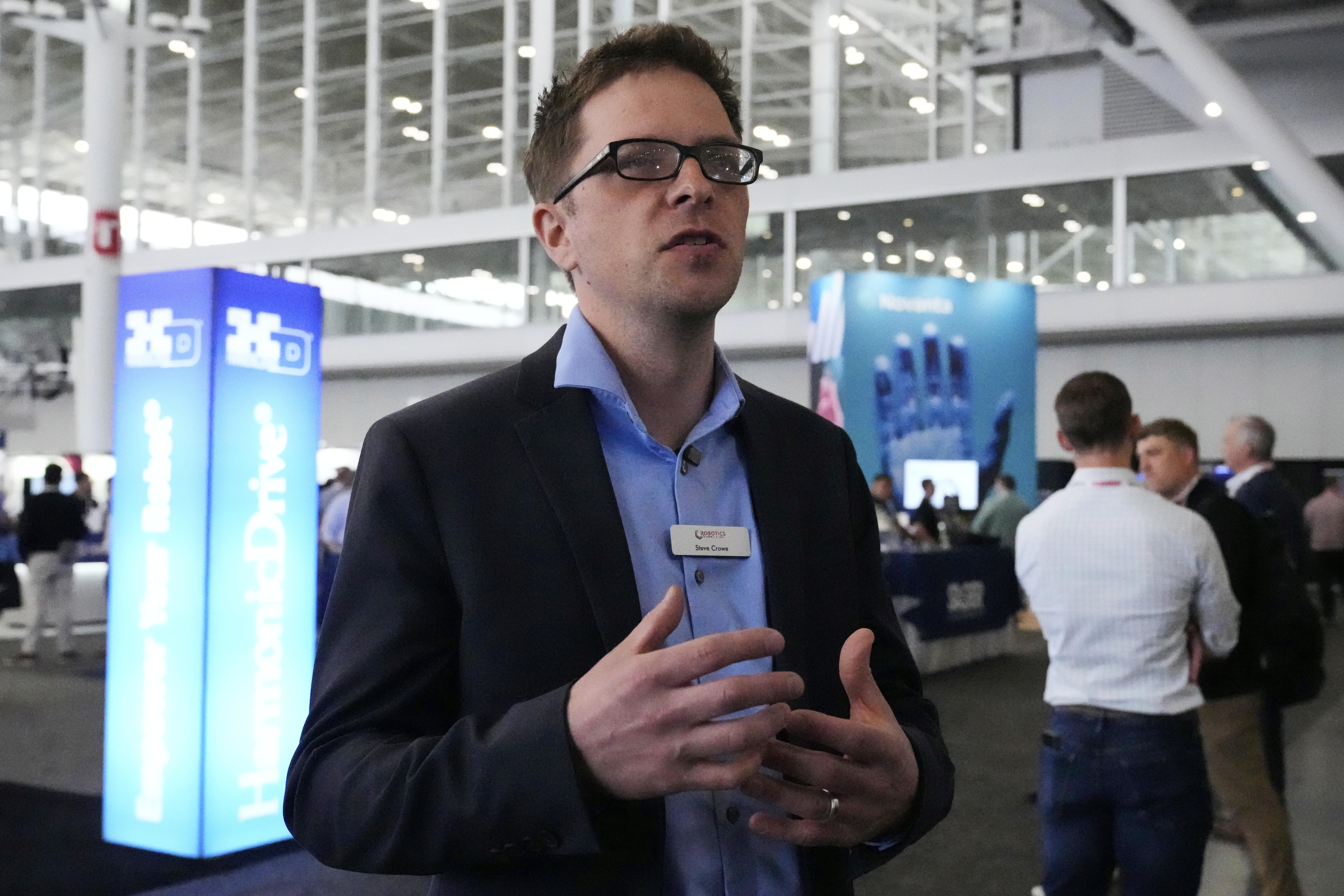 Steve Crowe, of the Robotics Summit & Expo, gestures during an interview on the convention floor, Wednesday, April 30, 2025, in Boston. (AP Photo/Charles Krupa)
