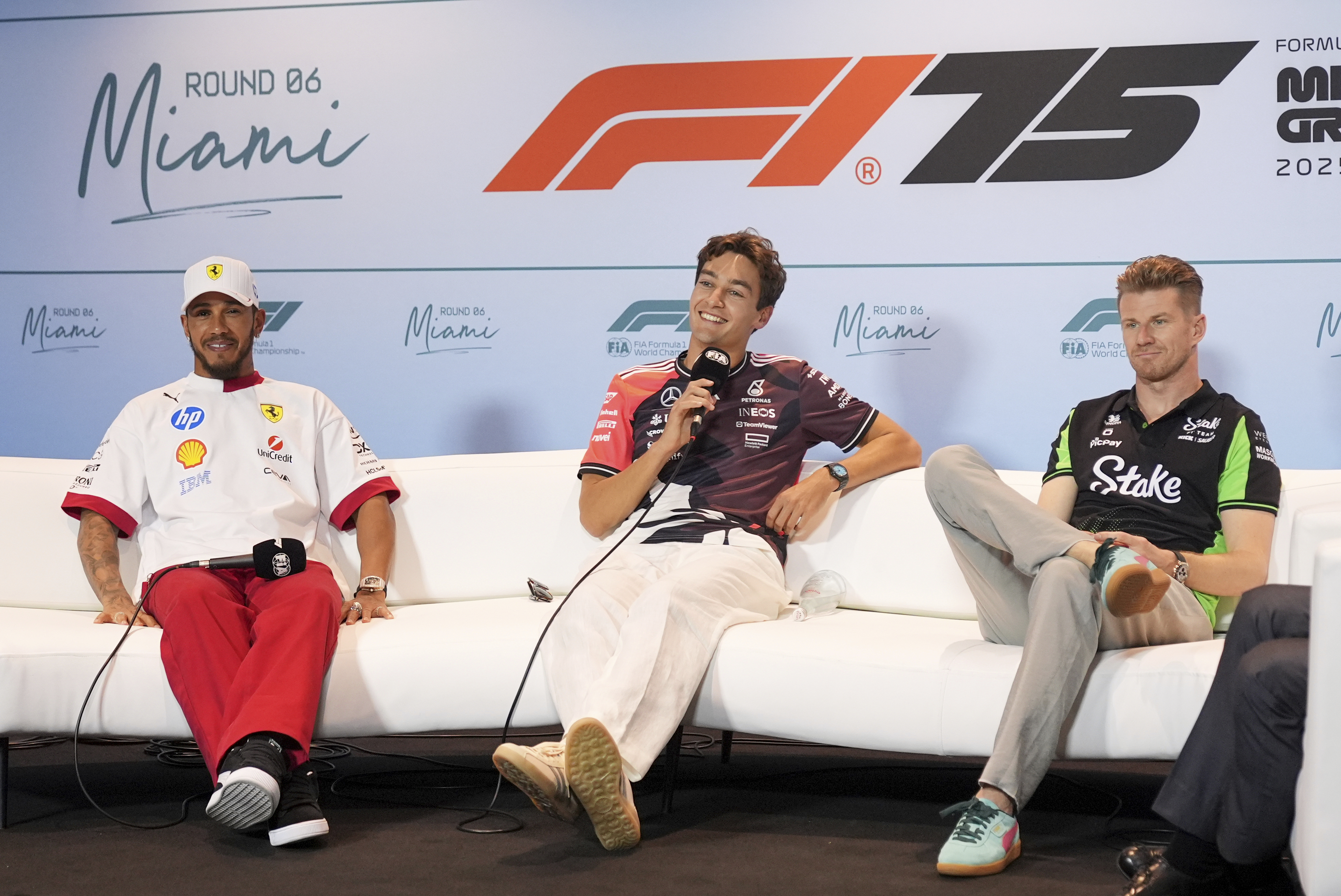 Mercedes driver George Russell, center, of Britain, answers a question as Ferrari driver Lewis Hamilton. left, also of Britain and Kick Sauber driver Nico Hulkenberg, right, of Germany, listen during a news conference ahead of the Formula One Miami Grand Prix auto race, Thursday, May 1, 2025, in Miami Gardens, Fla. (AP Photo/Rebecca Blackwell)