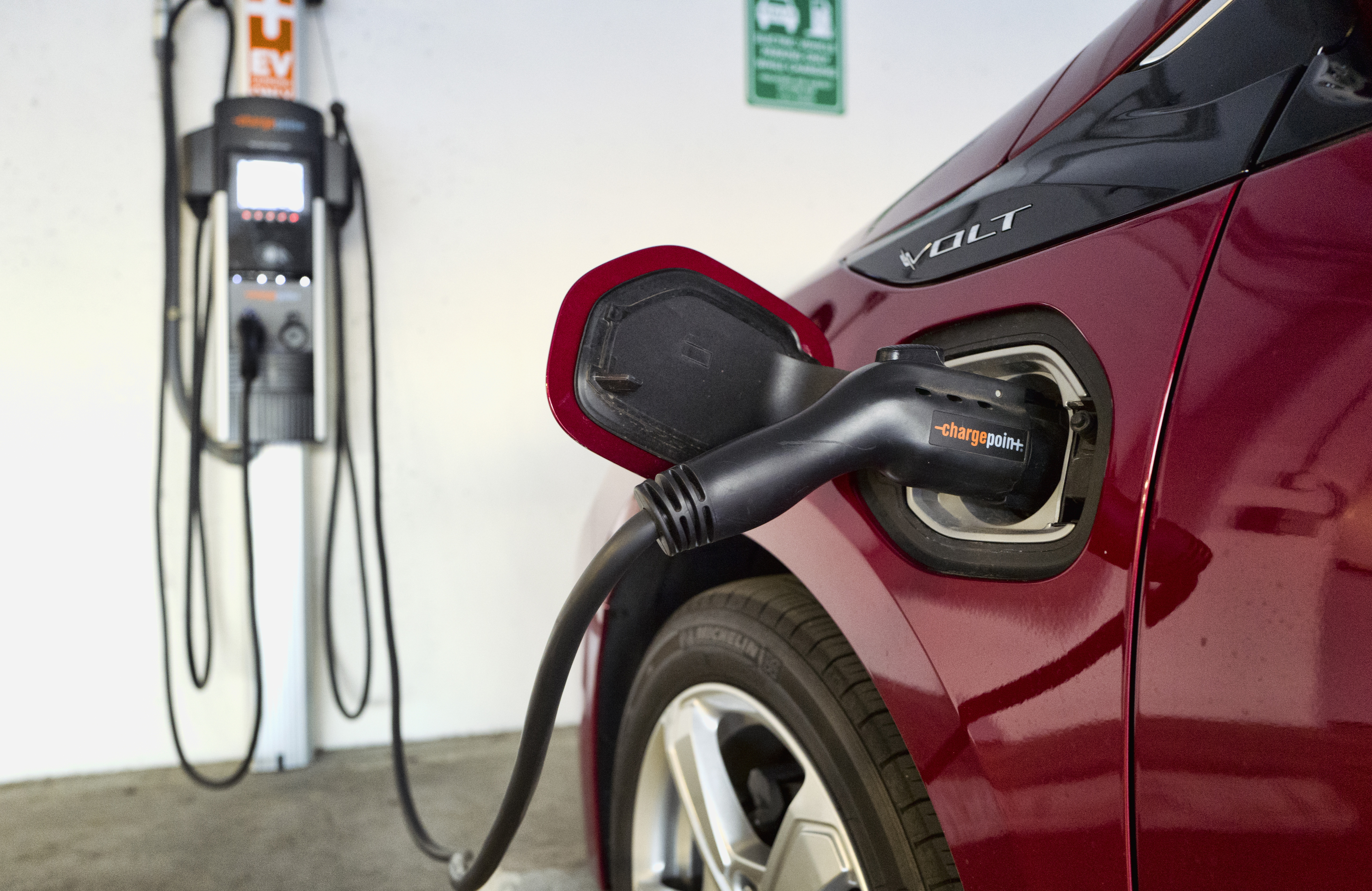 FILE - A Chevrolet Volt hybrid car is seen charging at a ChargePoint charging station at a parking garage in Los Angeles, Oct. 17, 2018. (AP Photo/Richard Vogel, File)