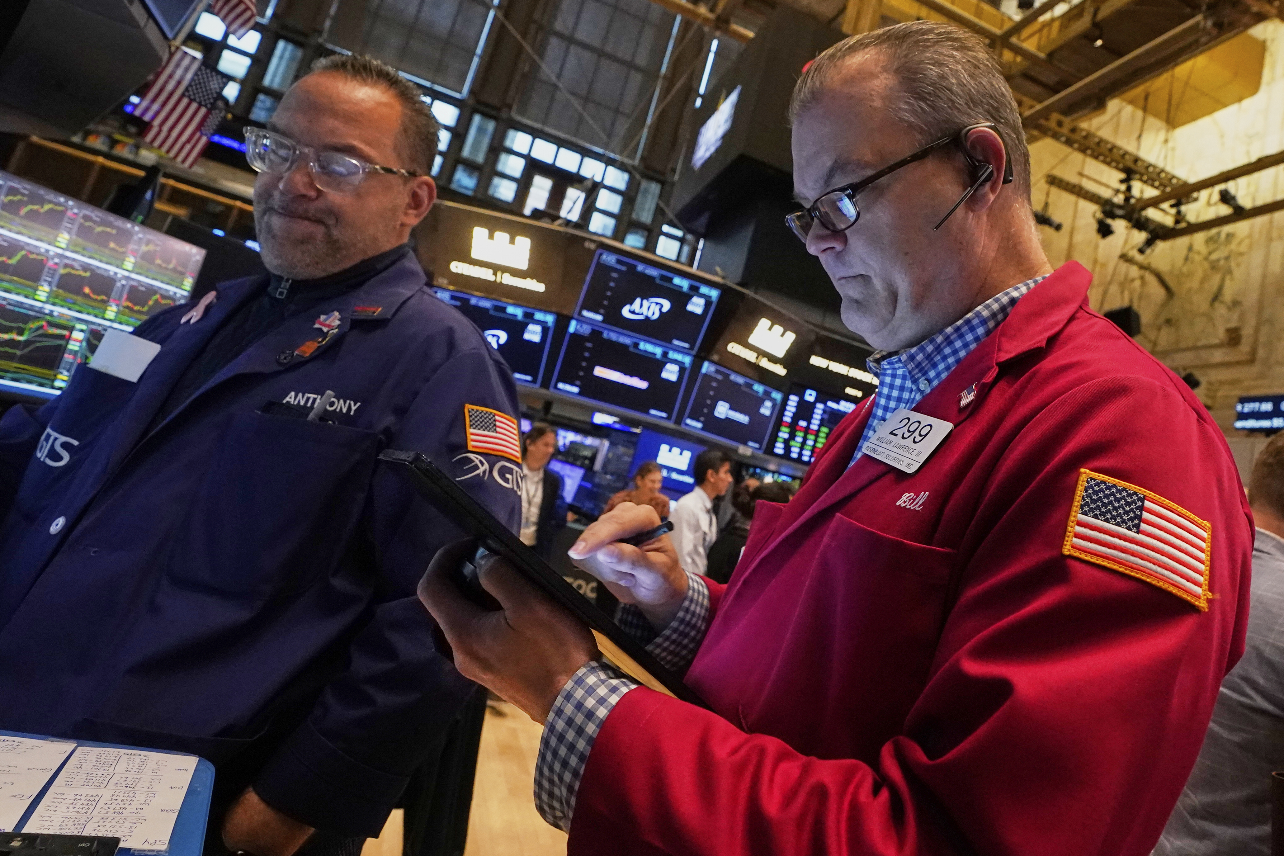 Specialist Anthony Matesic, left, and trader William Lawrence work on the floor of the New York Stock Exchange, Friday, May 2, 2025. (AP Photo/Richard Drew)